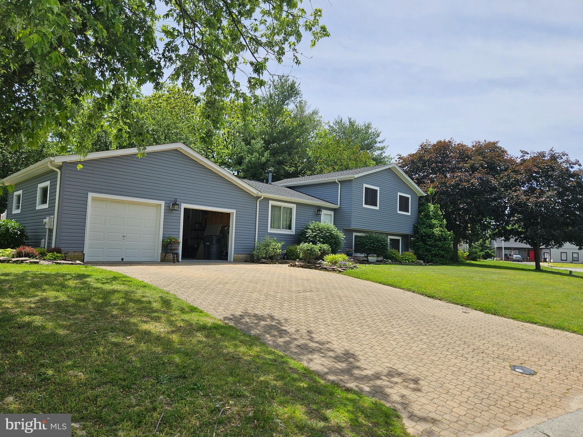 You will fall in love with this beautiful updated home. Has exquisite landscaping plus a beautiful stone driveway, walkway and steps. Home offers 4 bedrooms and 2 full baths. Numerous updates including roof, siding, gutters, HVAC system, paint and flooring. Offers a cozy gas fireplace for those cool evenings and beautiful kitchen with granite countertops. A large attached 2 car garage with epoxy floors and a wall of built in cabinets. Outside is a lovely private fenced in yard and a large deck for outside enjoyment. There is also an oversized shed for all your lawn equipment. All you have to do is bring your furniture!