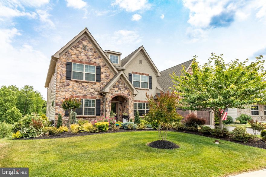 Absolutely stunning home shines inside and out! The former model in this, Keystone Custom Homes built, Scenic Manor community offers all the best in features and amenities. Impeccably appointed and generously upgraded, this home is sure to please. The stone-front Ethan Normandy model boasts over 5000sq/ft of living space, with 4 bedrooms and 3.5 baths on three levels. A modern gourmet kitchen with 10' granite island and stainless appliances opens into the morning room with cathedral ceilings and tree-lined views. Natural light floods the family room highlighting the stone fireplace, custom built-ins, and engineered hardwood flooring that spans the main and upper levels. The elegant owners suite featuring a lighted tray ceiling, dual walk-in closets, and a luxurious Venetian bath provides a spa-like retreat. Fully finished lower level offers a huge club room w/pool table, full guest bath, bonus room, and sliders to the extensively hardscaped rear patio and fire pit. Additional home features include oversized 2-car garage, dual water heaters, water treatment system, landscape sprinklers, patio lighting, and rear facing deck. Convenient to commuter routes, APG, renowned Bulle Rock golf course, historic Havre De Grace, wineries, and dining. You will love to call this home!