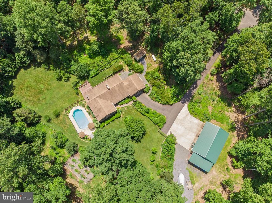Everything you are looking for in a quiet private setting in the country!  Just 10 minutes from Warrenton on private road.  Solid brick home surrounded my amazing landscaping and flower gardens, huge 4 car pole barn (30'x48') with 12' overhang plus attached 2 car garage, in ground pool to cool off on these hot summer days.  For the gardener there is a greenhouse and tons of flower gardens plus a fenced raised bed garden for vegetables.   The yard is fenced to keep the dogs in plus a shed for all the extras. Inside you will find a freshly painted interior, kitchen with cherry cabinets, granite counter tops and stainless appliances .  Sun filled large dining room with a door to the deck .  Family room offers brick hearth and wood burning fireplace, master bedroom with tiled shower.  two additional bedrooms with remodeled hall bath.  Lower level offers a possible in  law suite or rental unit.  Tons of storage,  second family room with brick hearth and fireplace, full bath, kitchen area and possible bedroom or workout room.   Enjoy entertaining on the deck  or take a dip in the pool!   Whole house generator!This home has it all!