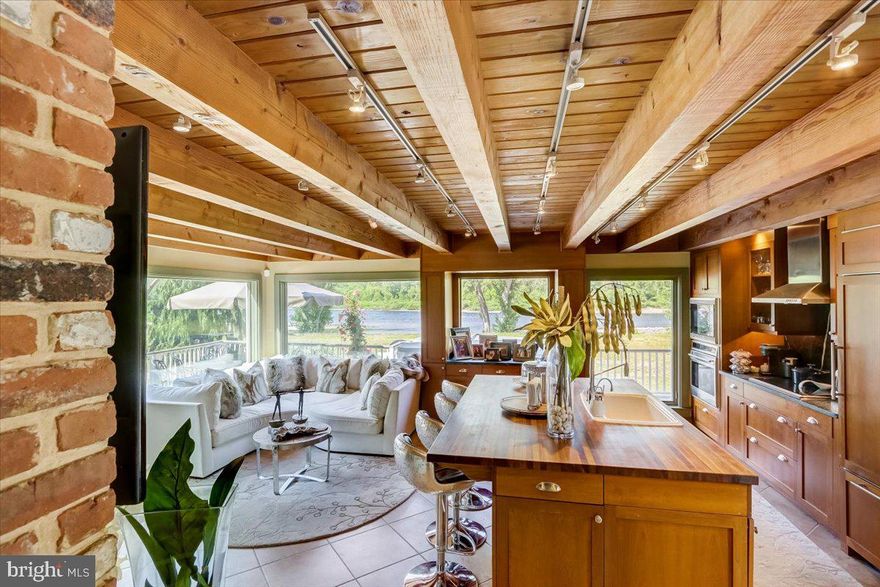 Step into your dream life effortlessly. This 1850 clapboard Colonial home is beautifully presented offering a lovely balance of open-plan living as well as cozy comforting spaces. Keeping intact the taste of the historic area to which it belongs, it is a home that lends itself to incredible entertaining opportunities due to its ample parking yet it is also an exceptionally intimate home that can be enjoyed privately throughout the seasons with its strong visual connections to the outdoors along the river and steps onto the Delaware and Raritan Canal State Park Trail, its private pool, and multi-tiered seating options. While outdoors, it is not unusual to see bald eagles soaring overhead as they nest nearby. Chef's kitchen with ample counter seating and a very comfortable companion area graced by expansive light-filled water views highlights the welcoming, inclusive vibe of the home. The living room's custom built-in cabinetry, wood-burning brick fireplace, and a seamless draw to the formal dining area all accentuate the natural grace and character of the home. On the upper level, the step-down primary bedroom accommodation with a walk-in dressing closet and a vaulted clerestory gives a feeling of added spaciousness while offering dramatic effect. Its en suite bath with jetted soaking tub as well as walk-in shower finish off this romantic space. The primary bedroom palette was chosen to create a restful feel while enjoying the ever-changing artistry of the river from every angle. Three remaining guest bedrooms and a full hall bath finish off the upper level. Attic space, with hallway pull-down access ladder, provides additional storage. With minimal property maintenance, you will have plenty of leisure time to enjoy historic Lumberville (home to the Black Bass Hotel, Lumberville General Store and the private members-only 1740 House; all within walking distance) and the neighboring towns of New Hope, Stockton, Frenchtown, and Lambertville.  Come for a weekend, stay for a lifetime!