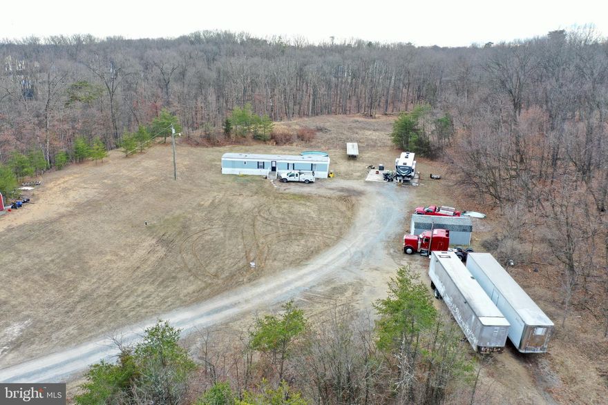 Discover the perfect opportunity to build your dream home on this 2.52-acre unrestricted lot in Falling Waters, WV—just minutes from I-81 for easy commuting! This property already has a well and septic in place, saving you time and money. A single-wide trailer is currently on-site and can be removed, making way for a fresh start. Whether you're looking for a private homesite or an investment opportunity, this land offers endless possibilities. Don't miss out on this rare find in a prime location!