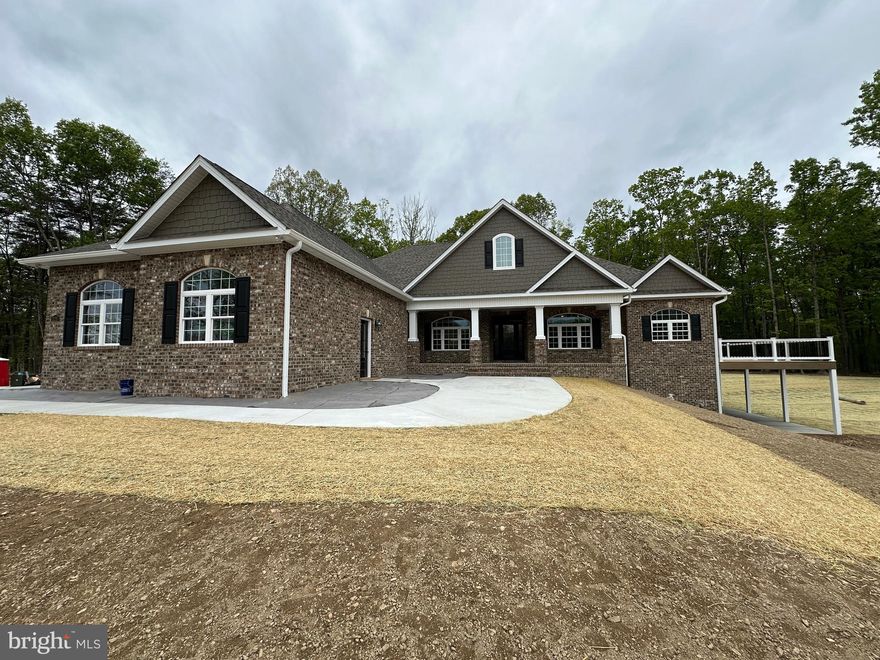 4-28-26  Very Close and Ready!   Delivery end April. Pictures are of subject property.
Seize a truly unique opportunity to own a brand-new, luxury estate set on over 7 acres of private, wooded land. While this stunning property sits at the entrance to the prestigious, upper-scale 15-lot Keplinger Estates community, it does not have HOA, offering unparalleled freedom and privacy.
Tucked gracefully off the main road, this secluded retreat provides a peaceful, close-to-town setting without compromising on tranquility and space.
Experience the pinnacle of single-level living in this immaculate residence, meticulously designed with a flowing 3,100 sq. ft. open floor plan. The builder has redefined "standard features," integrating premium elements throughout the home that others typically label as costly upgrades.
Key Features & Elegant Finishes:
Striking Curb Appeal: A distinguished full brick front complemented by durable cement siding creates a timeless exterior, highlighted by a large, welcoming concrete front porch and lead walk.
Exquisite Main Level: Rich, stained Early American hardwood flooring flows seamlessly across the entire main level, excluding the elegant tiled bathrooms and laundry room, creating a warm, inviting atmosphere.
Expansive Indoor/Outdoor Living: The home is designed for seamless entertaining and relaxation, featuring an extensive covered and screened deck that connects to open deck that wraps around the entire right side of the house.  Full patio under covered and open decks.
Walk-Out Access & Patio: The basement boasts convenient double-door walk-out access, opening onto a full-length concrete patio that extends from the breakfast room and continues beneath the expansive side deck.