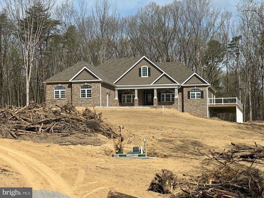 4-14-26   Getting close.   Delivery estimated end April.
At front of  Keplinger Estates near the Apple Pie Ridge area.
Seize a truly unique opportunity to own a brand-new, luxury estate set on over 7 acres of private, wooded land. While this stunning property sits at the entrance to the prestigious, upper-scale 15-lot Keplinger Estates community, it does not have HOA, offering unparalleled freedom and privacy.
Tucked gracefully off the main road, this secluded retreat provides a peaceful, close-to-town setting without compromising on tranquility and space.
Experience the pinnacle of single-level living in this immaculate residence, meticulously designed with a flowing 3,100 sq. ft. open floor plan. The builder has redefined "standard features," integrating premium elements throughout the home that others typically label as costly upgrades.
Key Features & Elegant Finishes:
Striking Curb Appeal: A distinguished full brick front complemented by durable cement siding creates a timeless exterior, highlighted by a large, welcoming concrete front porch and lead walk.
Exquisite Main Level: Rich, stained Early American hardwood flooring flows seamlessly across the entire main level, excluding the elegant tiled bathrooms and laundry room, creating a warm, inviting atmosphere.
Expansive Indoor/Outdoor Living: The home is designed for seamless entertaining and relaxation, featuring an extensive covered and screened deck that connects to open deck that wraps around the entire right side of the house.  Full patio under covered and open decks.
Walk-Out Access & Patio: The basement boasts convenient double-door walk-out access, opening onto a full-length concrete patio that extends from the breakfast room and continues beneath the expansive side deck.
Construction Update: Selections to be as depicted in example photos. Inquire to view this builder's impressive list of standard features.