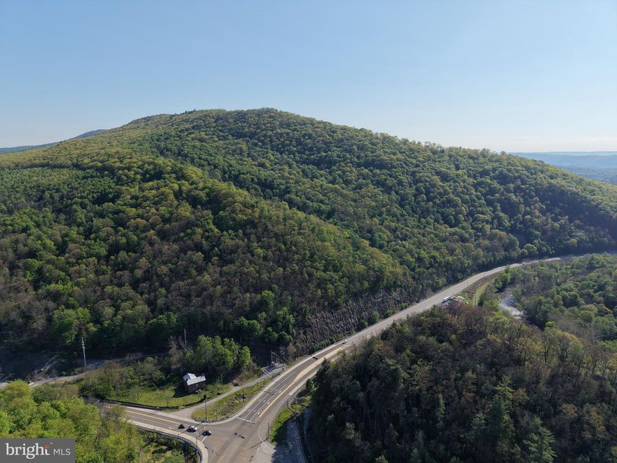 142.55+/- ACRES OF PRIME HUNTING LAND BORDERING ROTHROCK STATE FOREST! Great hunting and recreational property bordering approximately 96,000 acres of Rothrock State Forest, providing access to incredible additional opportunities for hunting, fishing, hiking, and outdoor recreation. This exceptional property offers abundant wildlife including deer, bear, turkey, and more. The property features frontage along William Penn Hwy (US Route 22), Shaffersville Rd, and Main St, and extends on both the north and south sides of US Route 22. The south side of Route 22 features a stream and also borders the Blair County Rails to Trails system, which runs alongside the scenic Frankstown Branch of the Juniata River.  Conveniently located with access to Huntingdon, Alexandria, Tyrone, Route 453, Route 22, Route 26, Route 522, and more. Also conveniently located just 13 miles from the Snyder Run Boat Launch at beautiful Raystown Lake! This property offers an excellent opportunity to own a great recreational tract.

This property will be offered at auction on Friday, July 31, 2026, at 1:00 PM. The list price in no way represents a minimum, starting, or acceptable bid.

This property will be offered in a multi-parcel auction, giving buyers the flexibility to purchase Tract 1, Tract 2, or both tracts. Tract 1: 142.55+/- Acres wooded land, Tract 2: 80.8+/- Acres wooded land.