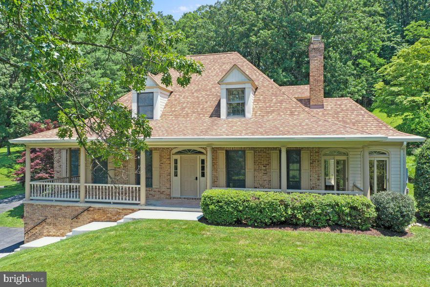 +++HUGE PRICE ADJUSTMENT!!+++
Welcome to this beautifully updated, all-brick, three-level Cape Cod, nestled on over two private acres with million-dollar panoramic views from the wraparound front porch. Over 3,400 sq ft of finished space!

This home blends timeless character with modern updates, featuring gleaming oak hardwood floors, custom six-panel oak doors, Anderson windows, and new recessed and designer lighting throughout.

The main-level primary suite impresses with hand-scraped hickory flooring, a custom dressing room, and a fully remodeled spa-like bath with marble flooring, a Roman walk-in shower with dual heads and bench, an Empava soaking tub, and a dual-sink marble vanity with LED anti-fog mirror.

The gourmet eat-in kitchen is a true showstopper—completely remodeled with 42" white soft-close cabinetry, under-cabinet lighting, a built-in spice rack, granite countertops, a large center island/breakfast bar, and brand new stainless steel appliances. Enjoy the convenience of a single-handle pull-down sprayer and pot-filler faucet. A custom walk-in pantry boasts butcher block counters and built-in shelving.

Perfect for entertaining, the kitchen flows into a custom-built wet bar with black pearl granite, glass cabinetry, and a wine/beverage cooler. The formal dining room retains original oak crown molding and chair rail, complemented by updated lighting. The spacious great room features a wood-burning brick fireplace and hardwood floors.

A bright and airy sunroom with French doors and tile flooring opens to a covered patio—ideal as a home office or quiet retreat.

A renovated powder room completes the main level along with a impressive laundry room conveys with quartz countertop, built in cabinetry and a brand-new GE Profile top load washer and dryer.

Upstairs are three additional bedrooms with new carpet and custom built-ins, sharing an updated full bath with dual-sink vanity and distinctive tile work. Don’t miss the walk-in cedar closet.

The finished lower level includes a rec room with new carpet, a full second kitchen, full bath, workshop, and utility room with access to the two-bay garage—ideal for vehicles and equipment.

Located in the sought-after Middletown School District, with easy access to shopping, dining, Route 340, Route 15 S to VA boarder, MARC train in Point of Rocks, Interstate 70 and 270.
**Survey completed for this property*