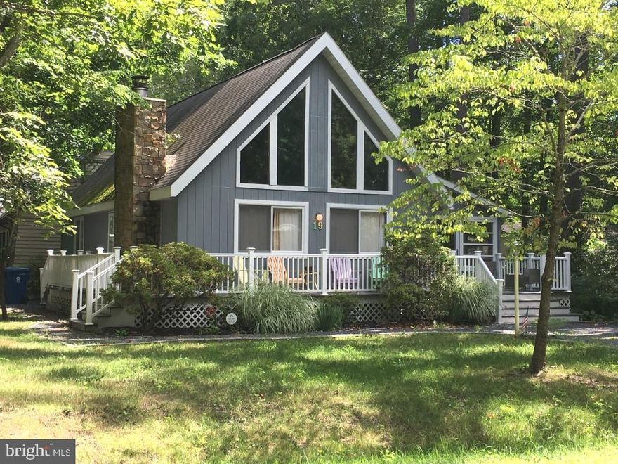 Cozy A Frame Chalet on a large wooded private high and dry corner lot on cul-de sac side of Newport Dr. 2 driveways allow for guest parking and a wrap around deck makes room for relaxing visits.
Inside you can enjoy the  'open concept' living/dining area with a brick surround fireplace. The large Primary bedroom and Full Bath and Laundry closet is located on the 1st level. Upstairs a 2nd Bedroom and full bath and Loft overlook the living space.  A 3 Season Porch with jalousied glass windows has views out to the private clearing used for casual gatherings in the spacious woodland yard.  Extra features include an attached shed and privacy outside shower. NEW ROOF Nov. 2023.
Conveniently located near the activities at the OP Community Center and close to the Swim and Raquet Club.  Owners have experienced a successful Rental Income history from Vacasa.