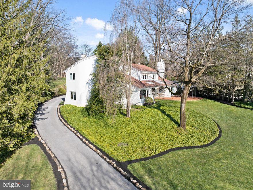 Indulge in the epitome of modern luxury living within this contemporary masterpiece, meticulously remodeled and professionally designed to evoke drama, elegance, and functionality. Situated on a serene double cul-de-sac neighborhood, this five-bedroom residence offers a unique three-dimensional living experience, seamlessly blending indoor and outdoor spaces. Bask in the tranquility of the landscaped grounds, featuring a swimming pool, terraces, and flower gardens, all visible through walls of sliding glass doors and large sunny windows.  Recently installed exterior lighting is automatically controlled by Lutron's Caseta System and designed to aesthetically and effortlessly guide you up the driveway and in full view of the stunning Japanese Maple that welcomes you home. Step through the grand foyer into the living room, where a fireplace, beamed ceiling, and dramatic curved wall create an intriguing and inviting ambiance. The adjacent dining room boasts abundant natural light and is perfect for hosting lively gatherings with family and friends. The eat-in kitchen is a chef's dream, showcasing double-glass cabinets, artisan hardware, and high-end appliances. The spacious family room, with its own fireplace and wall of glass, allows for maximum comfort and enjoyment while also seamlessly guiding you to the brick terrace and expansive yard beyond. The large, outdoor terrace adds yet another gathering space also wired for sound – al fresco cocktails, dining and grilling are the recipe for delicious fun & forever memories both inside and out!   
 
Discover a sumptuous first-floor bedroom suite with a limestone shower and private entry, ideal for guests or multi-generational living. Ascend the stunning cantilevered staircase to the luxurious primary bedroom suite, complete with a walk-in dressing room and spa-style bath. Three additional beautifully designed bedrooms and a full bath offer ample space for family or guests.  
 
The finished lower level provides additional living space, while recessed, dimmable lighting and a Generac generator add convenience and 24/7 peace of mind. The home features a premium geothermal HVAC system, purification enhancements to the home’s water and air handling systems throughout, LED lighting, and high-efficiency windows ensure both comfortable and sustainable living.
 
Centrally located in a very safe and sought-after neighborhood, this home offers easy access to award-winning schools, dining, shopping, commuter roads, and regional rail. With its ergonomic design and eco-conscious features, this modern home provides the perfect balance of sophistication and comfort, reminiscent of a Santa Barbara retreat.