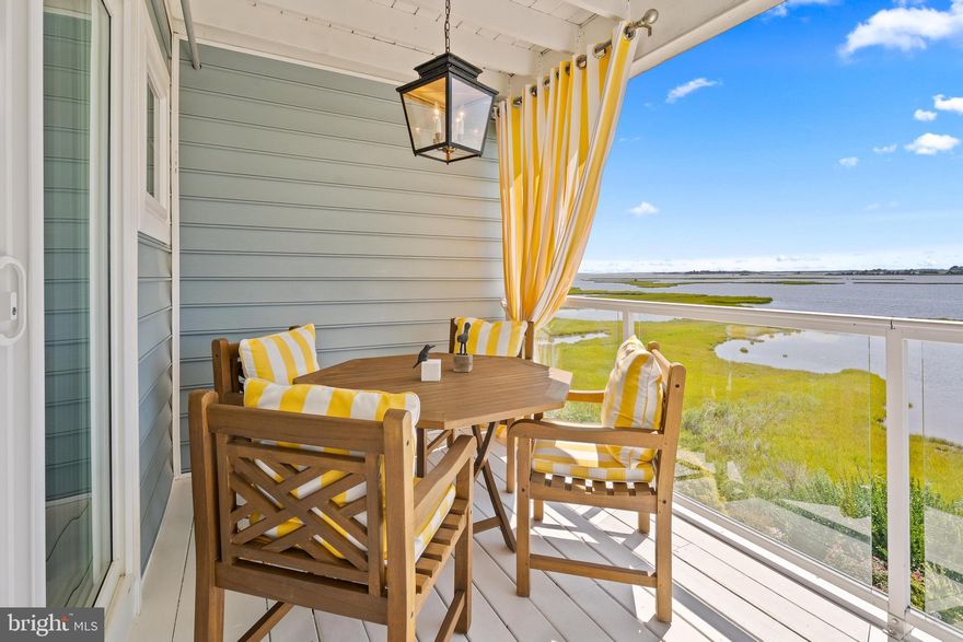 Welcome to this stunning 4-bedroom, 4-bath residence offering unmatched views of the Assawoman Bay and the iconic Ocean City skyline. Perfectly positioned to capture vibrant sunsets over the water, this home combines luxury, convenience, and coastal charm. Step inside to discover a thoughtfully designed floor plan with an elevator providing easy access to every level. The gourmet kitchen is a chef’s dream, featuring granite countertops, Bertazzoni range ,42-inch cabinetry, a spacious standalone island, and a peninsula breakfast bar. The expansive living room seamlessly connects to the kitchen and dining areas, creating an inviting space ideal for entertaining or simply relaxing while gazing out at the bay. Retreat to the primary suite, where oversized windows frame panoramic water views. The spa-inspired bathroom offers a jetted soaking tub, a separate walk-in shower, and dual vanities for ultimate comfort. Upstairs, a dedicated laundry room adds everyday convenience. With three generously sized bedrooms and four full baths, there is plenty of space for family and guests. Every detail has been crafted for both elegance and functionality, making this home the perfect bayside getaway or year-round residence. Whether you’re enjoying your morning coffee on the balcony, hosting friends in the open-concept living area, or ending your day with a sunset over the bay, this Mallard Cove retreat offers the best of coastal living.