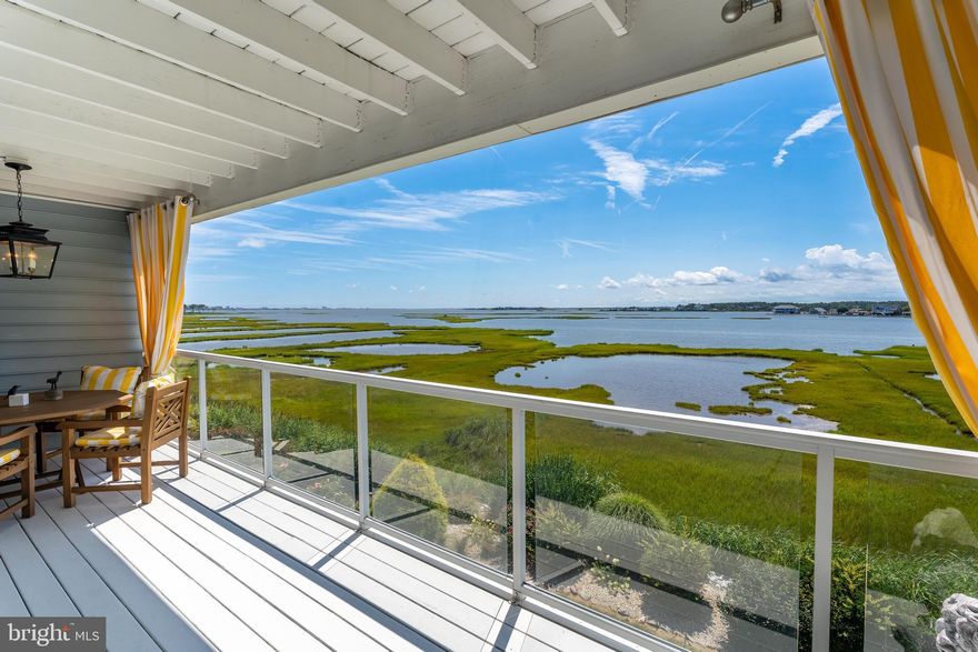 Welcome to this stunning 4-bedroom, 4-bath residence offering unmatched views of the Assawoman Bay and the iconic Ocean City skyline. Perfectly positioned to capture vibrant sunsets over the water, this home combines luxury, convenience, and coastal charm. Step inside to discover a thoughtfully designed floor plan with an elevator providing easy access to every level. The gourmet kitchen is a chef’s dream, featuring granite countertops, Bertazzoni range ,42-inch cabinetry, a spacious standalone island, and a peninsula breakfast bar. The expansive living room seamlessly connects to the kitchen and dining areas, creating an inviting space ideal for entertaining or simply relaxing while gazing out at the bay. Retreat to the primary suite, where oversized windows frame panoramic water views. The spa-inspired bathroom offers a jetted soaking tub, a separate walk-in shower, and dual vanities for ultimate comfort. Upstairs, a dedicated laundry room adds everyday convenience. With three generously sized bedrooms and four full baths, there is plenty of space for family and guests. Every detail has been crafted for both elegance and functionality, making this home the perfect bayside getaway or year-round residence. Whether you’re enjoying your morning coffee on the balcony, hosting friends in the open-concept living area, or ending your day with a sunset over the bay, this Mallard Cove retreat offers the best of coastal living.