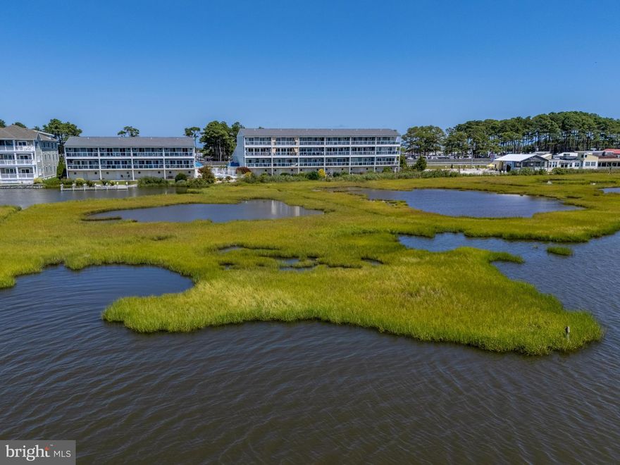 Welcome to this stunning 4-bedroom, 4-bath residence offering unmatched views of the Assawoman Bay and the iconic Ocean City skyline. Perfectly positioned to capture vibrant sunsets over the water, this home combines luxury, convenience, and coastal charm. Step inside to discover a thoughtfully designed floor plan with an elevator providing easy access to every level. The gourmet kitchen is a chef’s dream, featuring granite countertops, Bertazzoni range ,42-inch cabinetry, a spacious standalone island, and a peninsula breakfast bar. The expansive living room seamlessly connects to the kitchen and dining areas, creating an inviting space ideal for entertaining or simply relaxing while gazing out at the bay. Retreat to the primary suite, where oversized windows frame panoramic water views. The spa-inspired bathroom offers a jetted soaking tub, a separate walk-in shower, and dual vanities for ultimate comfort. Upstairs, a dedicated laundry room adds everyday convenience. With three generously sized bedrooms and four full baths, there is plenty of space for family and guests. Every detail has been crafted for both elegance and functionality, making this home the perfect bayside getaway or year-round residence. Whether you’re enjoying your morning coffee on the balcony, hosting friends in the open-concept living area, or ending your day with a sunset over the bay, this Mallard Cove retreat offers the best of coastal living.