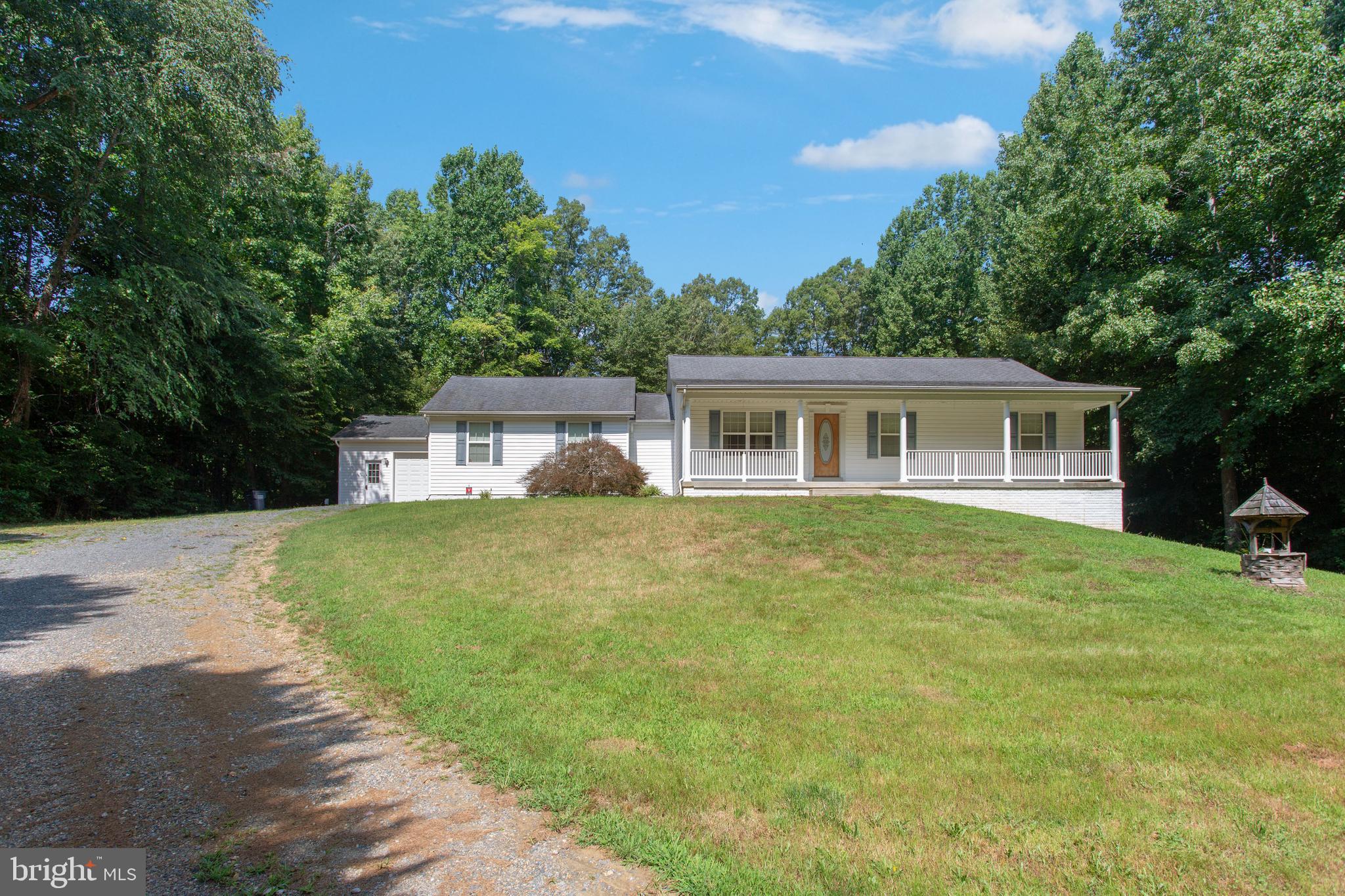 Beautiful 4 bedroom 3 full bathroom rancher situated on private picturesque 3 acres. Warm and airy entry way leads to open floor plan living space. Hardwood floors through out main living area. First floor master bedroom with two additional bedrooms on the first floor. Large newly finished walkout basement with another bedroom and full bath, could be used as an in law suite, rented or just a great private area to relax. Two car attached garage and bonus detached garage workshop area.