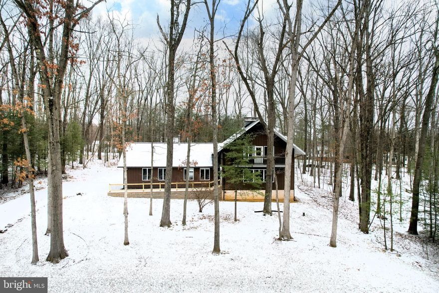 Nestled amongst the mature trees of Homestead Farms, you'll love the peaceful sense you get the moment you step into 637 Crandall Drive, State College. With an artistic vibe, this home celebrates the beauty of nature and has been lovingly updated, maintaining and enhancing the play between modern convenience and nostalgic lodge-like charm. From the stunning acacia floors to the Veronisi updated baths this contemporary home features a new septic system, new HVAC, a specialized new roof ideal for homes in forested areas, new front entry, updated lighting, new garage doors, and is freshly painted making it ready for you to move right in! Perfect for these frigid January days, you'll love cozying up with a good book next to the wood burning fireplace w/ insert in the formal living room with big windows overlooking the front yard. Your culinary adventures will be inspired by the wonderfully updated kitchen w/ white cabinets, 5 burner stove w/ hood, double wall oven, subway tile splash, custom concrete counters, farm sink, & SS appliances; including a new dishwasher. Share meals with your loved ones in the open concept dining room or enjoy a raucous game night in the spacious first floor family room. A versatile first floor bedroom makes for a great guest space or work from home office and has a half bath just across the hall. Upstairs you'll discover a serene primary suite w/ balcony, HW floors, custom built-in cabinetry, WIC, & charming private bath w/ tiled shower w/ glass doors & a stylish sink w/ round mirror. 2 additional nicely sized bedrooms & a 2nd renovated full bath w/ bathtub/shower also with glass doors and a heated tile floor complete the upstairs. Even on rainy days you'll have plenty of space for play in the partially finished lower level family room. The lower level also provides great hobby spaces, a laundry room, and a cool media room with industrial style. Outdoor living is a delight on the covered back porch and patio in the private backyard. You'll appreciate the 2 car garage and additional driveway parking spaces. When you decide to venture out, you'll love being right in the heart of the north end of town with close by shopping, schools, and a quick commute to campus. Don't miss exploring the nearby State Game Lands with hundreds of acres for recreation. You won't want to miss the special home!
