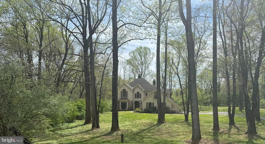 A true beauty! This architectural masterpiece may be your next treasured homestead. Perfectly positioned on a 1.4-acre cul-de-sac lot surrounded by custom homes, this exceptional residence offers unmatched curb appeal and is proudly located within the highly sought-after West Chester Area School District.  Step through the grand entrance and prepare to be impressed. A sweeping two-story foyer with a custom-crafted turned staircase welcomes you, setting the tone for the artistry and detail throughout. Enjoy the richness of extensive hardwood flooring, tray and vaulted ceilings, multiple fireplaces, and custom millwork—every inch of this home has been thoughtfully designed.  A formal fireside living room and a grand dining room create an inviting space for elegant entertaining or cozy family gatherings. A first-floor bedroom with an adjacent full bath provides a perfect guest suite or flexible multigenerational living option. At the heart of the home lies a beautifully designed updated island kitchen, complete with farmhouse sink, double ovens, furniture quality cabinetry with glass accents, a sun filled breakfast area and a fireside gathering space—ideal for casual mornings, Storytime, or catching up on homework. The finished daylight lower level adds incredible versatility, featuring a home gym, recreation area, dedicated workspace, and so much more.  Upstairs, your private retreat awaits. The impressive vaulted primary suite offers a fireplace, balcony access, and a designer bath with dual vanities, soaking tub, and a massive walk-in closet. Each secondary bedroom is ensuite, creating a peaceful oasis for every family member. You will feel like you are at the most sought-after resort sitting on the deck and enjoying the sound of birds or engaging in a soccer game.  Ideally located near major roads, shopping, and dining, this home combines elegant living with everyday convenience. This one-of-a-kind property truly has it all and borders about 250 acres of preserved land—schedule your private tour today and fall in love!