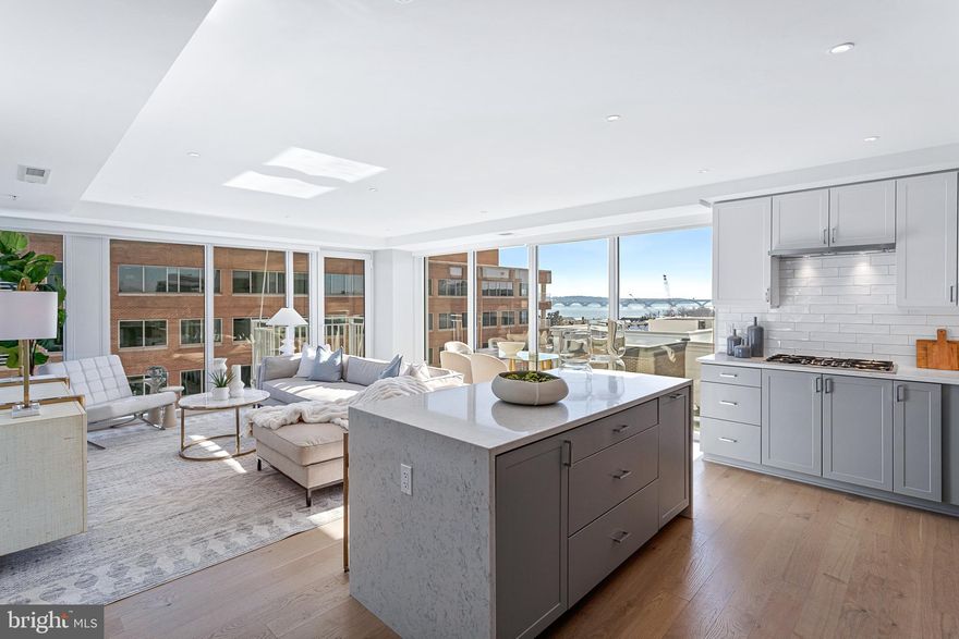 BRAND NEW THREE BED + DEN MODEL (CORNER UNIT) at Old Town's newest luxury condominium building, VENUE! Built by renowned local developer, Carr Companies, the finishes in this building are extraordinary. Chef's kitchens feature Bosch appliance packages, Quartz countertops, and custom cabinetry. This particular Three Bedroom + Den sits on the Southeast corner of the building offering 1800 sq ft of living space and views of The Potomac River from every room! FLOODED with natural sunlight and overlooking the Mt. Vernon trail, this residence also offers a view of The Capitol from its east-facing balcony! The owner's bedroom with en-suite bath features a double vanity and walk-in shower with a 5-point showerhead & detachable nozzle, Bianca Carrara walls & floors, and a custom built-in linen center. UPGRADES GALORE! Includes SEVEN custom built-in systems, recessed lighting throughout, brilliant control display, and wet walls in the bathrooms. A total of 7 closets allow for ample storage, including large walk-in closets in the owner's suite and third bedroom, a reach-in in the second bedroom, an extra large closet in the foyer, a pantry in the kitchen, and a linen closet in the powder room. VENUE offers a turn-key elevated lifestyle. Enter through the hotel-style Porte-Cochere into our Grand Lobby, where you will be met by our Full Service Concierge and on-site building manager to assist with your every need. The building features a sprawling Rooftop Terrace offering expansive panoramic views of the DC Monuments, Potomac River and Old Town skyline, as well as an outdoor grilling station and fire pit seating area. The elegant indoor Owner's Sky Lounge is equipped with flat-screen TV's, a fireplace, and a cocktail bar, perfect for entertaining! Relieve your stress in the State-of-the-art Fitness center complete with a Barre studio. VENUE is the ideal location in Old Town's most desirable neighborhood, right in the center of entertainment, restaurants, and shopping, with direct access to the Mount Vernon Trail. This is a MUST SEE THREE BEDROOM + DEN!! Immediate occupancy is available. Come see what all the fuss is about!