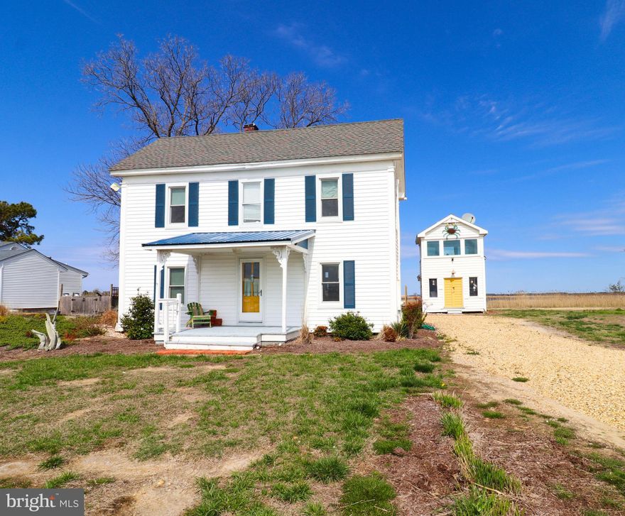 Escape to this charming waterfront retreat, where stunning panoramic views of the Tangier Sound await you at every turn! This coastal hideaway offers the perfect blend of relaxation and adventure, whether you're unwinding on your private beach just across the street or gathering around the brick firepit in the backyard. For those who love exploring the water, a small dock out front provides easy access for launching a kayak—take advantage and immerse yourself in the surrounding beauty!

Inside, the home exudes warmth and character, featuring gorgeous hardwood floors, vaulted ceilings in the living room and sunroom, and a cozy step-down kitchen with a breakfast bar. The upstairs bedrooms boast breathtaking water views from both the front and back, creating a serene escape. A smaller downstairs room, currently serving as a utility space, could potentially be converted back into a third bedroom. Hosting guests is a breeze with the detached bunkhouse, which includes two additional bedrooms and sleeps up to five additional persons! 

If that's not enough, the home has been thoughtfully updated with brand-new hardiback siding, LVP flooring in the kitchen, new plumbing throughout, and energy-efficient mini-splits for year-round comfort. The downstairs bathroom has been completely remodeled, featuring a stunning tiled shower. 

Whether you're looking for a full-time residence, a vacation getaway, or a prime investment opportunity for Airbnb, this home is ready for you—fully furnished and move-in ready! Plus, the septic system is less than five years old.

Don’t miss your chance to own this idyllic waterfront retreat!