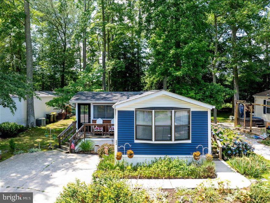 Experience coastal living in this vibrant, amenity-rich Rehoboth Bay MHP community. This charming home features two bedrooms positioned at opposite ends for added privacy. Enjoy your morning coffee or an afternoon drink on the screened porch or the small front deck, which overlooks the fountain pond. If you enjoy gardening, you'll love the beautiful flower garden space where you can plant your favorites or care for the existing plants. Situated about 4 miles from the Rehoboth Beach Boardwalk, this home offers an affordable vacation getaway or a perfect year-round residence in Rehoboth. Discover why this home is ready to be enjoyed in any season and why it might be the ideal choice for you!