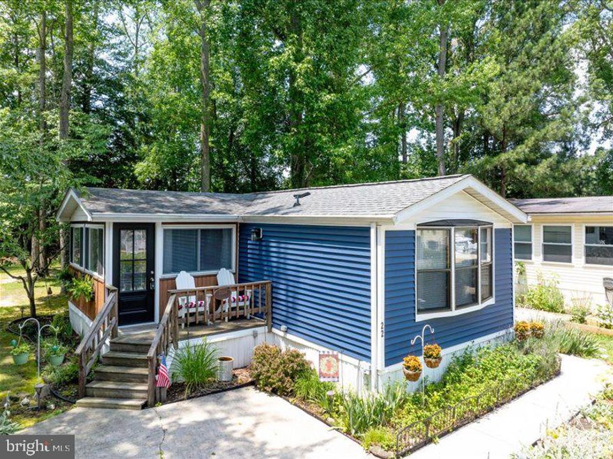 Experience coastal living in this vibrant, amenity-rich Rehoboth Bay MHP community. This charming home features two bedrooms positioned at opposite ends for added privacy. Enjoy your morning coffee or an afternoon drink on the screened porch or the small front deck, which overlooks the fountain pond. If you enjoy gardening, you'll love the beautiful flower garden space where you can plant your favorites or care for the existing plants. Situated about 4 miles from the Rehoboth Beach Boardwalk, this home offers an affordable vacation getaway or a perfect year-round residence in Rehoboth. Discover why this home is ready to be enjoyed in any season and why it might be the ideal choice for you!
