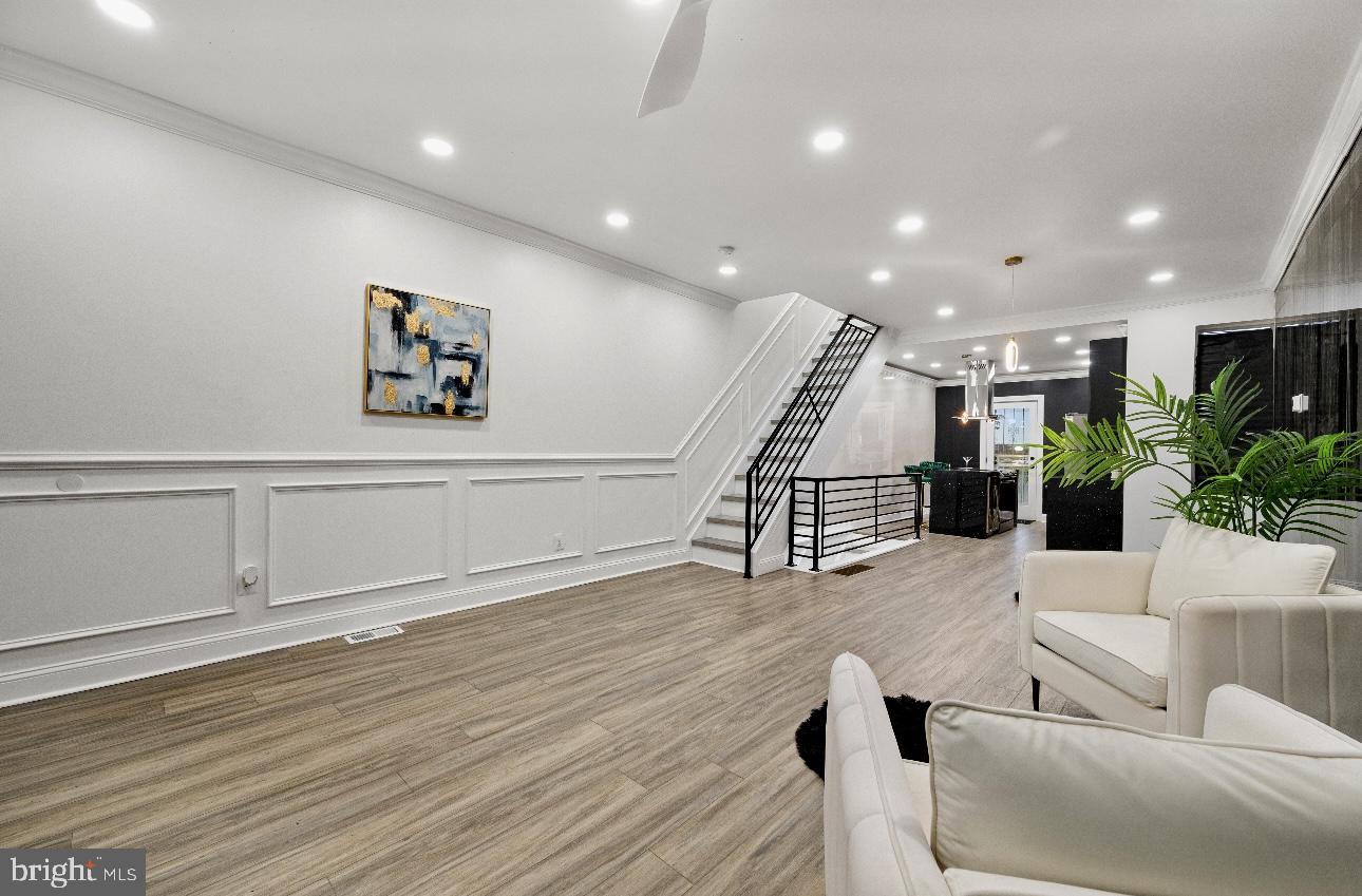 This home is absolutely stunning with four bedrooms, two full bathrooms and almost 2000 sqft of finished living space. Step into luxury living! The alluring living room will wow you. The tile accent wall is breathtaking. Great attention to detail was paid throughout the home. It’s been fully and meticulously renovated from top to bottom. From the unique light fixtures to the lovely wainscoting and chair rail. Everything just comes together beautifully. The open floor plan is great for entertaining. Fall in love with the illuminated Gourmet Kitchen, which boasts sparkling quartz countertops, ultra chic flat panel soft close cabinets, a microwave drawer, a wine fridge, and Stainless Steel appliances. The gold fixtures are the perfect touch. The island hood is a really nice feature. Just outside the kitchen door you’ll find the ultimate bonus space, a large bi level deck with a view of the skyline. Just imagine how creative you can get with this space. Barbecues , parties, entertaining, receptions, yoga, or just relaxing and catching a breeze. On the lower level of the home there is a fully finished basement with a luxurious full bathroom with a spacious shower and a stand alone tub. There’s a tv to enjoy while soaking in the tub compliments of the seller. Sophisticated round LED mirrors and floating vanity that feel like a 5 star hotel. The tile is exquisite. There’s a family room with another tv, a laundry area with a washer and dryer, and a bedroom or flex room that walks out to the large lower deck with a little dog house included. The deck is illuminated. The lights really look great at night. You can even change the colors. Similar optional led color lighting is available in the kitchen and basement. Upstairs there are three good sized bedrooms. They all have ceiling fans. There’s another gorgeous bathroom. The home is nestled on an extremely quiet cul de sac street in University City. Perfect location close to the University of Penn, Saint Joseph’s University City Campus, HUP, and Children’s Hospital. You’ll be walking distance to the Schuylkill River Trail, Clark Park, and Bartram Gardens. All these great outdoor spaces right outside your door. PHL Airport is only 10 minutes away. You could get to Center City and less than 10 minutes. South Philly is just over the bridge. Take advantage of this rare find at a great price. Schedule your showing today and put your offer in. This gem won’t last long!
