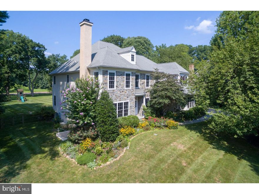 Move right into this custom crafted stone manor home, set on a spectacular private 1.38 acre flat lot that backs up to acres of open space. This impeccably maintained beautiful 5 bedroom, 4 full and 2 half bath home is light-filled with 9' ceiling heights, gleaming site finished hardwood floors, stunning millwork and moldings, two story foyer, gracious room sizes and a wonderful open floor plan. Fabulous gourmet eat-in Kitchen has custom cabinetry, oversized island with second sink and seating for 4, granite counter tops, stainless appliances, open to Breakfast Room with french door out to the blue stone slate patio and stunning rear yard. Kitchen opens to Family Room with coffered ceiling, a floor to ceiling stone fireplace, and a wall of windows. Additional features on the first floor: Living room with gas fireplace, Dining Room with wainscoting, Butler's Pantry with wine refrigerator, Office/Den, mudroom with built in cubbies, two powder rooms, and convenient 2nd staircase.  Hardwood floors continue on the second floor hallway and loft/sitting area. The spacious Master Suite has a sitting area, two walk in closets, Master Bath with two sink vanities, Jacuzzi tub, walk in tiled shower with bench and private water closet. On this floor there are 2 additional Bedroom Suites, 2 bedrooms joined by a jack and jill bath and a spacious Laundry Room.  The walk up attic and unfinished walk out lower level provide room to expand. Absolute move-in condition and just minutes from the town of Bryn Mawr with train, shops, and restaurants. Convenient to Center City and the Philadelphia International Airport. Serviced by the award winning Radnor Schools.