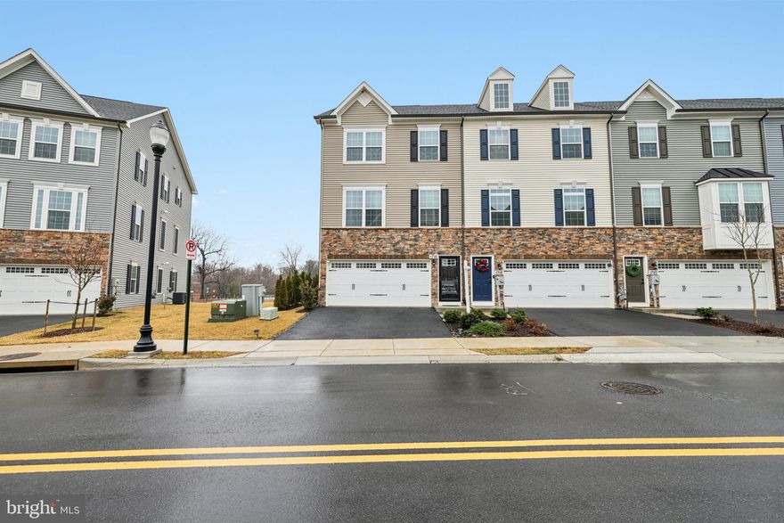 Welcome to this stunning end-unit townhouse built in 2023, located in the desirable Bel Air Farm community. Perfectly positioned near the neighborhood trails and park, this home offers modern living with thoughtful design and exceptional comfort.

Step inside the open-concept main level filled with natural light from expansive windows. The heart of the home is the chef’s kitchen, featuring a spectacular 12-foot center island, abundant cabinetry, and seamless flow into the dining area. The inviting living room showcases custom built-in bookshelves, integrated lighting, and a dedicated space designed for a 75-inch TV. Just off the living room, enjoy outdoor relaxation on the private deck overlooking the community walking trail, complete with modern privacy screens.

The upper-level features three spacious bedrooms and two full bathrooms. The primary suite offers a luxurious en-suite bath with double vanity, soaking tub, stand-up shower, and walk-in closet. A convenient top-floor dedicated laundry room makes daily living effortless.

The fully finished lower level adds incredible versatility with a fourth bedroom, private full bathroom, and custom kitchenette equipped with a built-in microwave, mini fridge, sink, and cabinetry. With sliding doors leading to the backyard and access through the garage, this level is perfect for an in-law suite, guest quarters, or private living space.

Outside, the seller enhanced privacy by lining the yard with arborvitae trees.

With 4 bedrooms, 3.5 bathrooms, a garage, modern finishes, and flexible living spaces, this nearly new home offers the perfect blend of style, comfort, and convenience in one of the area’s most sought-after communities. Conveniently located near shopping, dining, commuter routes, and of course downtown Frederick!