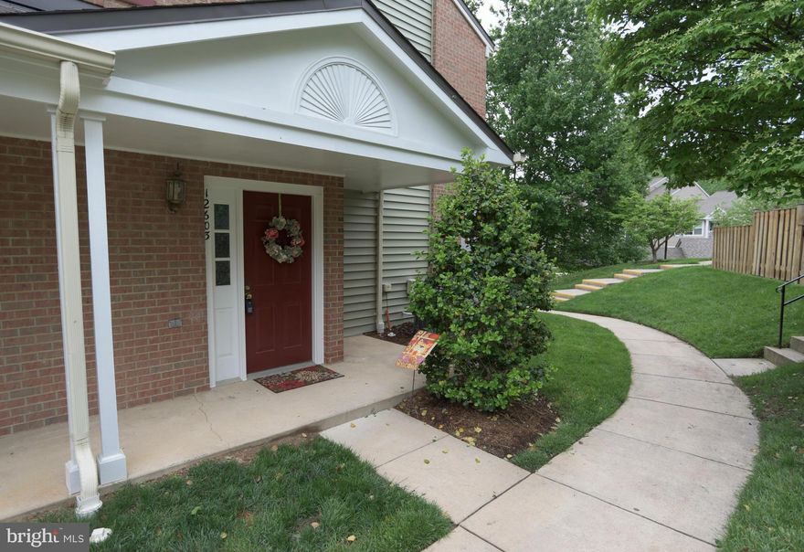 Beautiful brick end unit with wooded back yard, patio, and balcony..Newer neutral carpeting throughout..shows like a model home..lots of lights..gourmet kitchen with granite ctops, stainless steel appliances...eating table space...upgraded  remodeled bathslow gas util. great community amenities, ample parking, terrific elem. school.. 10++ great square footage..