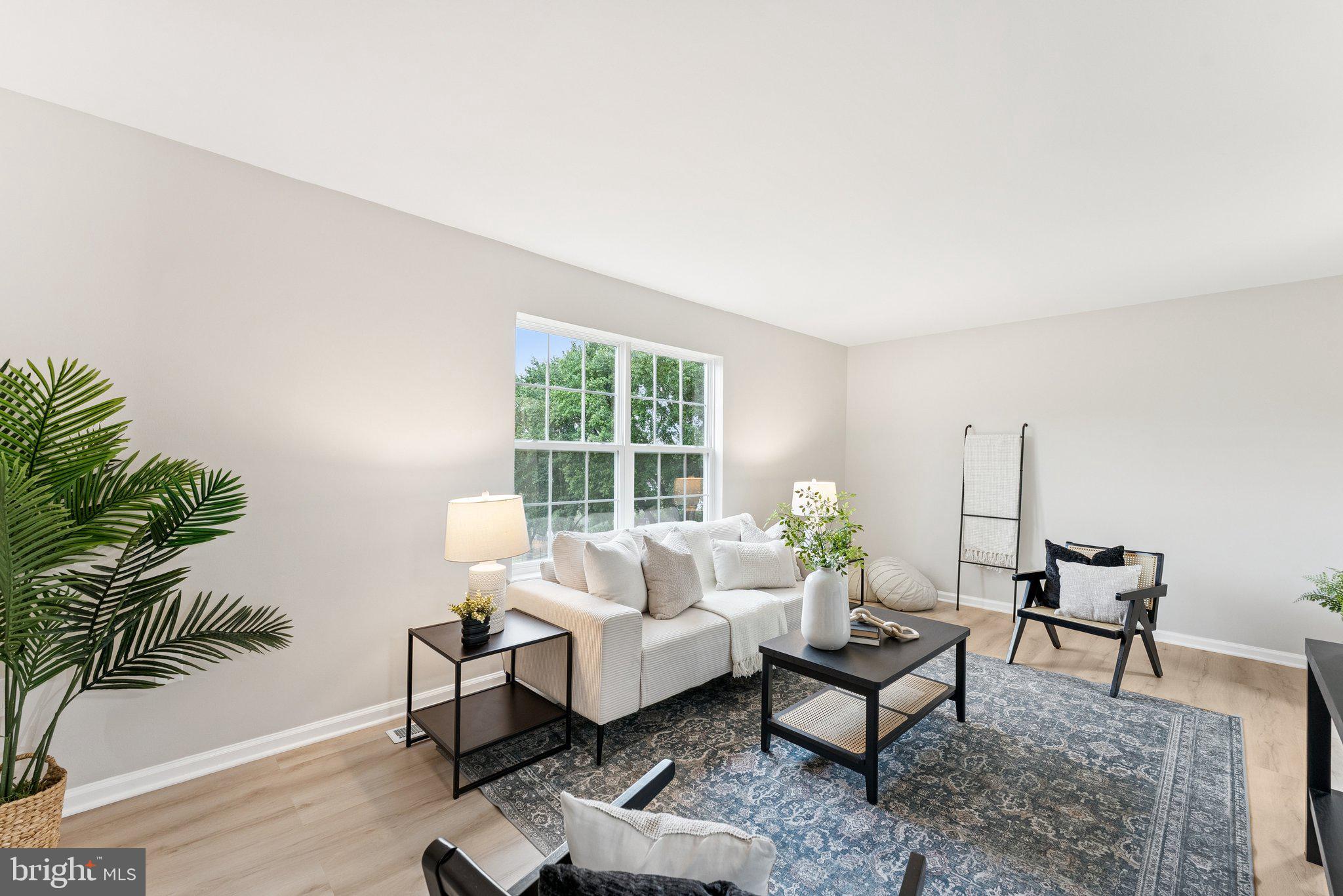 As soon as you step inside, you are greeted by bright, refreshing natural light and a home that has been renovated inch by inch. The brand new LVP flooring flows seamlessly through the main level, where a spacious dining room opens into a thoughtfully designed kitchen.
The kitchen features brand new cabinets, quartz countertops, subway tile backsplash, and all new appliances including GE and LG. A single-well stainless steel sink with a sleek faucet makes meal prep quick and easy.
Just beyond, the light-filled living room offers flexibility for a large sectional or a cozier seating area with space for a desk. Perched high in the neighborhood, the living room windows frame views of mature trees, and they are brand new too.
The lower level continues with fresh carpet on the stairs and LVP flooring for a clean, continuous look. A convenient half bath is tucked in the hallway, perfect for guests. Upstairs, you will find updated bedrooms with thoughtful closets, along with a beautifully renovated bathroom featuring honeycomb floor tiles, subway tile with a built-in shelf, and stylish cabinetry and lighting.
With newer windows throughout, modern finishes, and plenty of storage, this home is truly move-in ready. All the updates have been done and you will not need to touch a thing.