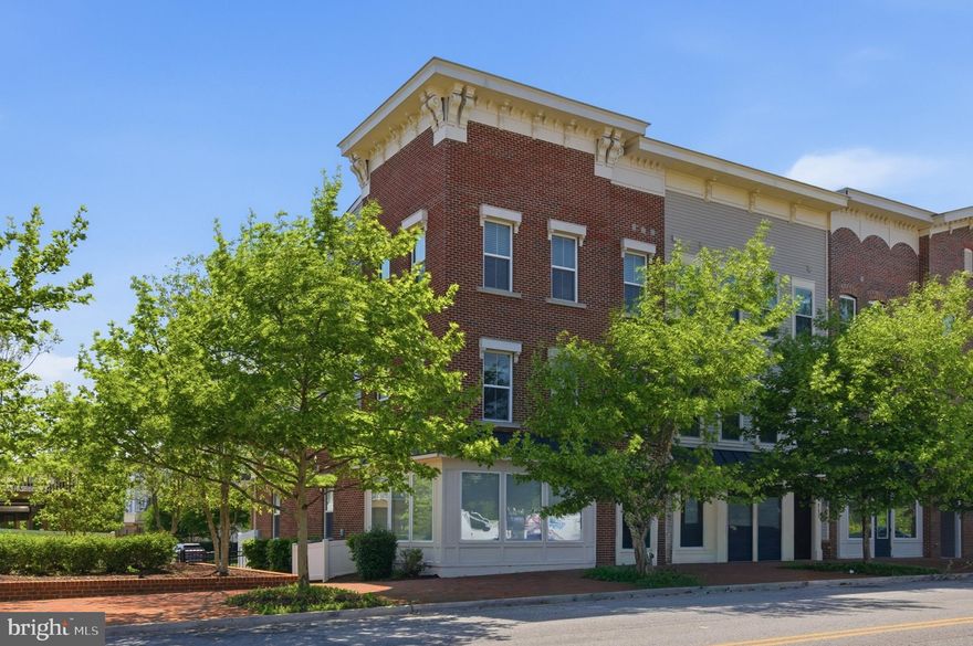 This exceptional end-unit residence in the stately Village Greens of Annapolis is bathed in natural light from 14 additional windows not found in typical interior models, beautifully highlighting the engineered hardwood floors throughout the main levels. The pristine condition, spacious interior, and amazing location combine to create a move-in-ready home and a fabulous Annapolis lifestyle.

The heart of the home is a chef’s dream kitchen, complete with premium cabinetry, a large center island with seating, a pantry, and a cozy gas fireplace, making the space a warm, sophisticated gathering spot. Transition through elegant doors to a private deck, perfect for outdoor relaxation. The main level also provides distinct spaces for both formal dining and comfortable living, beautifully illuminated by newly updated light fixtures, along with a convenient half bath. 

The upper level features a charming loft-style nook ideal for a library, exercise space, or sun-drenched reading corner. The primary sanctuary boasts soaring high ceilings, four large windows, and two generous walk-in closets, plus a spa-like bath with a double vanity, soaking tub, and separate shower. Two additional bright bedrooms, a second full bath, a linen closet, and a dedicated laundry room complete the top floor. 

The open and airy main level transforms effortlessly to meet your every need, from a light-filled great room, spacious home office, or high-end home gym, to a creative studio, guest quarters, or in-law/au pair suite with its own entrance and half bath. Functional luxury continues with the attached rear-entry two-car garage and private driveway, which together provide ample parking and additional storage space. 

The location is second to none, just minutes from Historic Downtown Annapolis, Eastport, and local marinas. Enjoy the convenience of living near the US Naval Academy, with opportunities to tailgate at Navy football games, watch the Blue Angels during commencement week, and attend concerts and events at the Naval Academy Chapel. Nearby Routes 50 and 97 offer a seamless commute to Fort Meade/NSA, BWI Airport, Baltimore, and DC. This elegant, refined, and move-in-ready residence is the upscale Annapolis home you have been dreaming of. Welcome home!