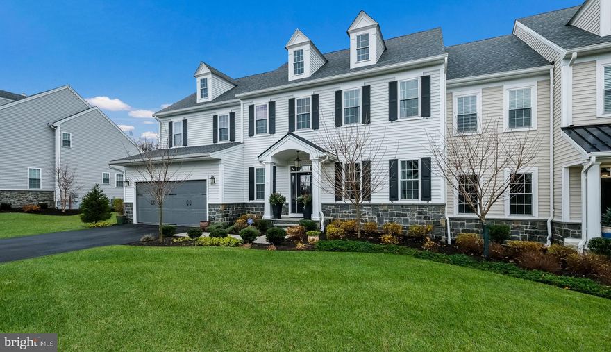 Welcome to 208 Manor Road, a meticulously maintained carriage home nestled within the coveted Squires Ridge community. With a serene landscape, this residence offers both low-maintenance living and a peaceful retreat. Constructed in May 2021 by Foxlane Homes, one of the region’s premier builders, this 3 bedroom, 3.5 bathroom home with a 2 car garage boasts an array of upgrades.
Upon arrival, you'll be greeted by a charming bluestone covered porch, leading you into the inviting foyer adorned with wide plank engineered hardwoods and boasting 10-foot ceilings throughout the first floor. The flex room, perfect for a home office or quiet retreat, sets the tone for comfort and functionality. The adjacent laundry room and family entry, featuring custom trim detail, ensure convenience upon arrival from the garage.
Step into the main living area, designed with today’s lifestyle in mind. The expansive 2 story great room is bathed in natural light streaming through three sets of French doors with transom windows above. A gas fireplace, accented with shiplap and a live edge mantle, adds warmth and character to the space. The chef's kitchen is a culinary delight, featuring a large, centered island with ample seating, quartzite countertops, and cabinetry with storage above behind glass inset doors. Custom backsplash with open shelving, GE Café’ stainless appliances, a 6-burner oven, wall microwave, and second oven cater to every culinary need. Additional counter space, cabinetry, and a beverage fridge complete the picture, while the walk-in pantry boasts custom closet organizers for added convenience.
Adjacent to the kitchen, the dining room welcomes you with a vaulted ceiling and access to the outdoors. The primary bedroom, located on the main level, offers spaciousness and serenity, boasting a large walk-in closet with exquisite organizers. The primary bath is a luxurious retreat, featuring dual sinks, ample counter and drawer space, ceramic tile, framed mirrors, and a lavish walk-in shower with a frameless glass door.
Upstairs, a generously sized loft area offers versatility for various uses, accompanied by two bedrooms, each with ensuite bathrooms and walk-in closets. The finished lower level provides generous space for a secondary family area, home gym, or entertainment, while a customized space with 10-foot ceilings lends itself to a golf simulator and/or versatile storage/workshop area.
Outside, the covered screened porch leads to a bluestone patio with a built-in gas fireplace, offering a serene escape with a tree-lined backdrop. Squires Ridge is a 55+ community sitting on 32 beautiful acres. 20% of owners can be under 55 years of age. You’ll love the proximity to Wissahickon Valley Park, restaurants, shops and major traffic routes such as 476 and 309, which makes it a desirable location for convenience and leisure. 
Schedule a showing today and embark on the journey to find your next place to call home!