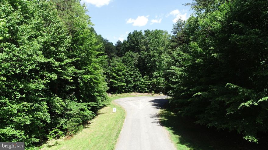 Enjoy quiet tranquility on this two-acre building lot on the Public Side of Lake Anna. Situated on a Cul-de-Sac, this lot offers deciduous trees that provide dappled shade,and a gentle slope of the land that may accommodate a walk-out basement. The property backs to a 93-acre wooded parcel for even more privacy. The convenient location of Freshwater Estates places you close to shopping, your favorite restaurants, micro-breweries, cidery, and a highly-rated golf course. The location on the water allows you easy access to the larger areas mid-lake, and local marinas. Boat slip # 72 conveys in the Community Common Area. The gated Common area offers picnic tables and a recently extended boat ramp. This property is not on the Community Mass Drainfield, so the HOA dues are reduced.  Be sure to walk this spacious lot and revel in its privacy and peaceful splendor.