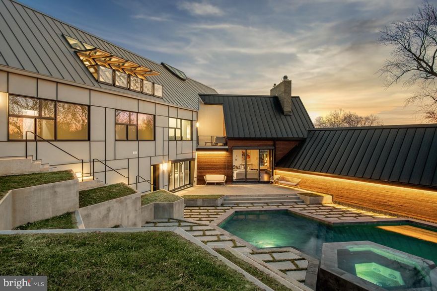 STUNNING NEW CONSTRUCTION in sought after LANGLEY DISTRICT of MCLEAN, VA!!! 
A timeless masterpiece beautifully constructed to continuously inspire and entertain. 
This thoughtfully designed and TRULY custom-built home is for those looking for a functional residence boasting brilliant architectural and high-tech features! Spanning over 8,400 sq ft of living space, here is a home featuring premium building materials combined with lavish finishes! You'll love coming home every day with voice activated options as you prepare for winding down at home in your sauna or a spa experience after an evening at the gym. A long driveway leads to a spacious 3-car garage with an exterior built to protect this space from pesky critters. The  stunning 9 ft wide gas fireplace that exudes a Ritz-Carlton vibe alongside the main showstopper, the grandeur of the home;  a stunning CIRCULAR staircase, symbolizing strength  from basement to roof, with a breathtaking skylight showcasing its beauty . Step into an office with inspirational elements that elevate your mindset, and if you have a passion for pizza, become the go-to host with your very own pizza oven. Entertain guests with not just a massive TV screen, but a staggering SIXTEEN 55-inch screens – who needs a movie theatre? The surprises continue around every corner, from FIVE Juliette Balconies overlooking the modern pool,  jetted hot tub,  stadium-style landscaping and sunset views of Tysons!
Inspired by Piet Mondrian and Frank Lloyd Wright, this residence is a masterpiece of avant-garde architecture. Shou Sugi Ban siding seamlessly blends ancient Japanese craftsmanship with contemporary aesthetics. The property boasts repurposed trees, a memorial wall, and a Civil War-era kettle, connecting the home to its rich past. Beyond historical and artistic elements, this home offers modern amenities, including a state-of-the-art entertainment system and a luxurious primary VOICE-ACTIVATED SPA for daily serenity.
This McLean residence isn't just a home; it's an immersive journey through art, history, and innovation. It embodies architectural splendor, sustainability, and luxury, surpassing expectations at every turn. Awarded as a Worth masterpiece, no other builder could replicate the unwavering attention to detail invested from inception to completion.
Describing this home adequately is a challenge – it's a one-of-a-kind experience. For the complete experience, consider a private guided tour.  Elevate your living experience in a residence that captures the essence of modern luxury.