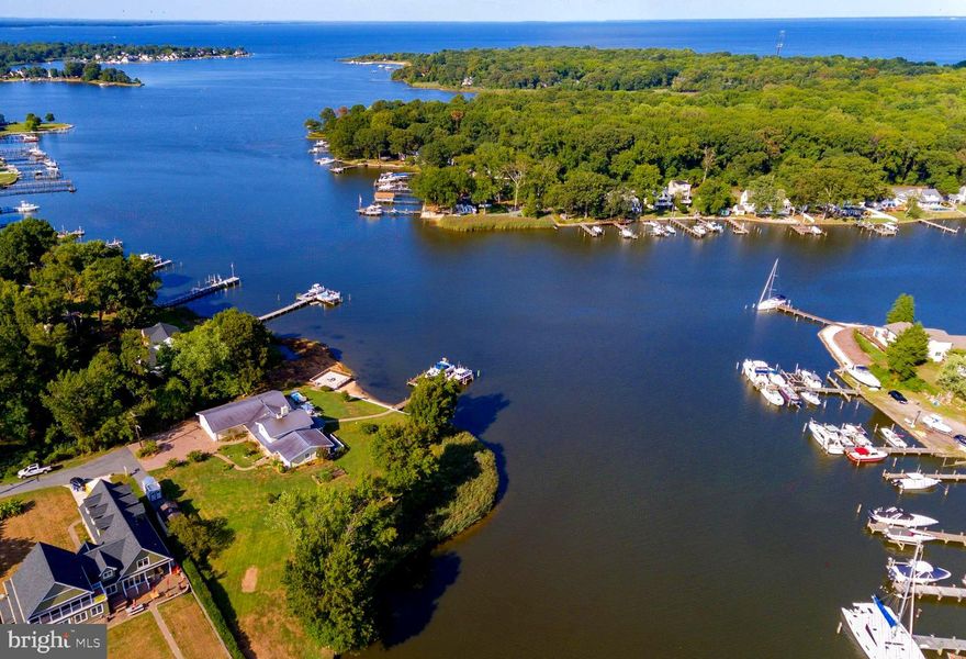 Sought after and rare point of land home on Bodkin Creek. Deep water and privacy on over 350' of Waterfront footage. This well appointed home has luxury finishes and astounding views clear to the Chesapeake Bay. Dock w dual lifts, over-sized garage, beautiful hardscapes, Swim Spa, hardwoods and recent addition of a true Chef's Kitchen with Butler's Pantry, custom cabinetry, Calcutta Gold marble & walnut counters as well as Built in appliances and cathedral ceilings and beams to start. Enjoy multiple Entertaining spaces indoors and out. You will not be disappointed the moment you set foot on this compelling piece of paradise.