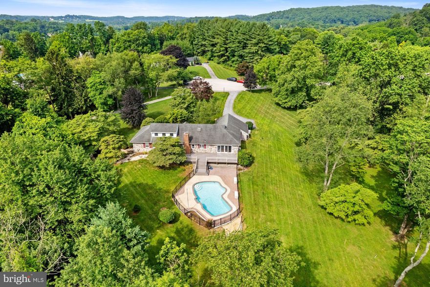 Tucked away on a sprawling 2.9-acre lot in a quiet cul-de-sac, this custom home offers privacy, personality, and an entertainer’s dream setup. At the heart of the home is a stunning vaulted-ceiling great room with a wall of windows overlooking the fenced-in pool and massive rear deck, an outdoor oasis perfect for summer gatherings. From this space a spiral staircase leads to a lofted hangout space and a fourth bedroom, offering flexible living options for guests, work, or play. The eat-in kitchen is spacious and inviting with ample storage and prep space for your daily routine. Enhanced by a cozy brick fireplace, you'll also find additional access to the rear deck.  Not to be missed, a formal living and dining room offer additional square footage to make entertaining a breeze. Enjoy the best of one level living with a full primary suite with a private ensuite bath as well as two additional bedrooms on the entry level. Not to be missed, the 2 car garage and unfinished walk-out basement add even more usable space to grow with your needs. Major upgrades include a brand-new septic system (being installed), a whole-house Generac generator with buried propane tank, and stone exterior that enhances the home’s rustic charm. Located in the award-winning Downingtown Area School District, just a short walk to historic Yellow Springs, this is a one-of-a-kind property for buyers seeking space, character, and a resort-style retreat close to everything- Schedule your tour today!