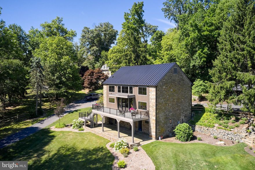 Who doesn’t love a converted barn?! This stone bank barn, originally built in 1850 has been lovingly transformed into a modern residence without compromising the integrity of the barn’s original features. 
Step inside to discover the beauty of exposed beams, open loft concept, and the impeccable craftsmanship of a complete renovation. With everything rebuilt from the ground up, this residence is essentially a brand new house… enjoy the peace of mind provided by all new mechanicals, plumbing, electric, windows, siding, roof and brand new septic system. The home features 3 bedrooms and 3 full baths, one conveniently located on each floor. The expansive living spaces are bathed in natural light, highlighting the exquisite details and finishes throughout. Nestled on 5.28 picturesque acres, with detached 2 car garage and additional storage sheds. An oversized flagstone patio and deck provide the perfect setting for entertaining or simply relaxing while overlooking the serene, parklike setting with a tranquil pond. The lush landscape and mature trees offer a private oasis where you can enjoy the beauty of nature right at your doorstep. Don't miss the opportunity to own a piece of history with all the comforts of modern living.