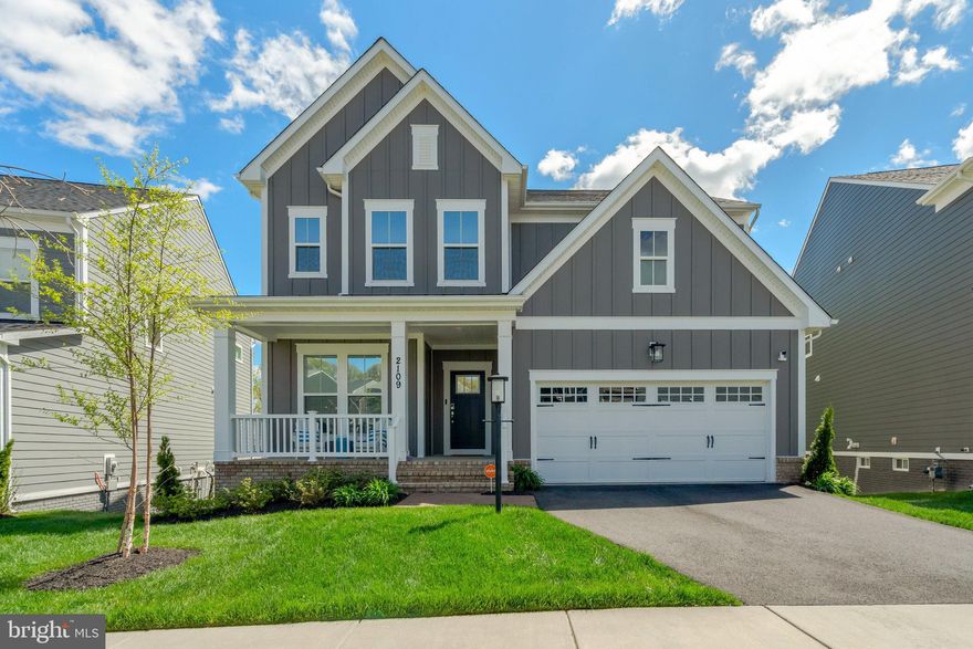 An impressive residence built in 2022 with 5 bedrooms and 5 bathrooms, seamlessly combining modern features with timeless classic style.  Set on a premium lot in prestigious Potomac Shores, this home offers a sought-after location that maximizes privacy and stunning views.  The front window overlooks open space, with the home across the street oriented away; meanwhile, the rear windows and deck showcase stunning vistas of treetops and the Potomac River. This premier setting blends tranquility and scenery, providing the perfect balance of seclusion within a vibrant and exclusive community, ideal for luxurious yet comfortable lifestyle living.

The transitional floor plan greets you with an impressive sightline from the front door to the rear of the home, emphasizing open, airy living spaces. Thoughtfully designed, the main level features a bedroom and full bathroom, providing convenience and accessibility for guests or multigenerational living. The breakfast area, with its sliding door, opens to a Trex deck—a perfect retreat for savoring serene mornings or unwinding in the peaceful ambiance of nature.

In the heart of the home, the living room features two custom bookcases flanking the fireplace, adding elegance and practicality. Remote-controlled undershelf lighting enhances these bookcases, allowing you to adjust the ambiance to suit any occasion.

Upstairs, the design masterfully combines privacy with practicality. A spacious loft serves as the central hub, separating the junior suite, which includes a private ensuite, from the primary suite and two additional bedrooms.  The upper-level laundry room is thoughtfully located near the bedrooms and equipped with a utility sink, seamlessly combining practicality with convenience to enhance the ease of everyday living.

At the end of the hall, the primary suite becomes a sanctuary. It features a tranquil sitting area and a spa-inspired bathroom with dual showerheads. From this vantage point, enjoy breathtaking views of the river and the surrounding community.

The fully finished basement offers exceptional versatility and abundant space, complete with a full bathroom and sliding doors that seamlessly connect to the outdoors. Its generous layout provides ample room to create an additional bedroom while maintaining expansive living areas, making it ideal for entertaining, a sophisticated home office, or a recreational retreat. With limitless possibilities for customization, this space elevates the home's overall functionality and charm.

Equipped with modern amenities designed to elevate your lifestyle, such as: a whole-house water filtration system with a softener for pristine water quality; an upgraded HVAC system with an air scrubber and U/V light for healthier air; professionally installed tint on all windows/sliding doors for added comfort and energy efficiency; underground front yard sprinklers for effortless maintenance; and a custom hall tree at the garage entrance helps keep space organized and clutter-free.

This extraordinary home offers stunning views, luxurious details, and modern conveniences, all nestled within a welcoming community that balances tranquility with easy access to world-class amenities. Located near Shores Club pools, gym, social barn, plus Potomac Shores Golf Course, Clubhouse, and Tidewater Grill, this home provides the best location and lifestyle for residents of all ages.

Potomac Shores features an extensive list of amenities, including swimming pools, a Fitness Barn perfect for workouts/yoga, multipurpose sports fields, and numerous walking trails. Various social activities, with opportunities for kickboxing, cooking classes, Sip-and-Paint nights, book clubs, and more. The community fosters connections through hobbies and passions, offering something for everyone.

Effortless commuting with access to I-95, and a community VRE station, now under development, enhances convenient travel.

Plan your appointment today for refined living tomorrow!