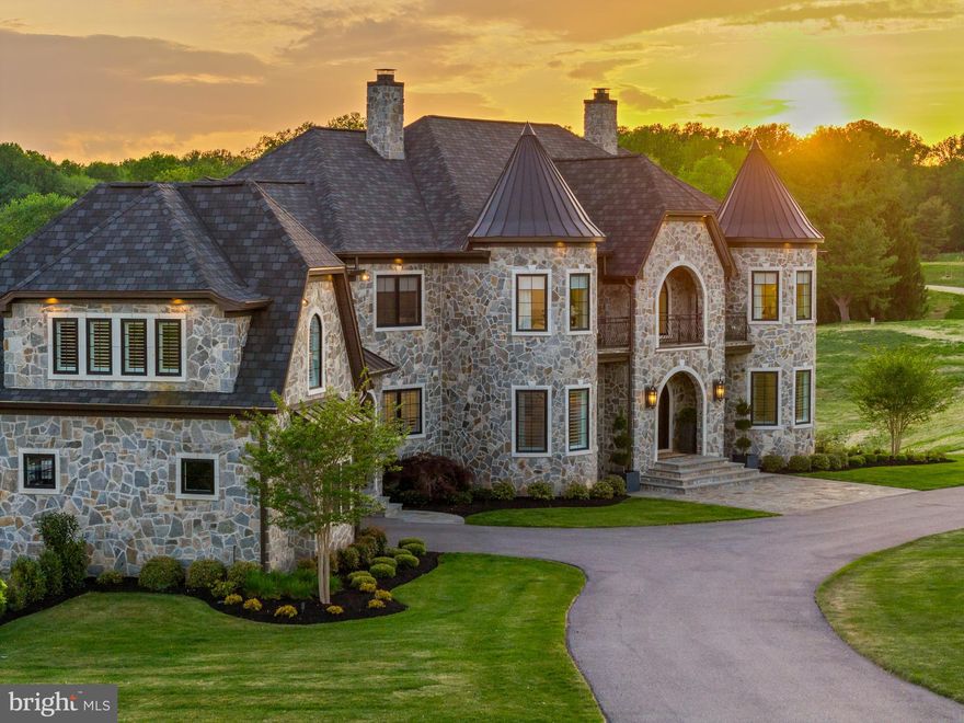 A truly one-of-a-kind offering. An incredibly rare and unique opportunity to own a masterfully curated and fully custom designed home in Baltimore County’s newest and most coveted enclave, Castanea Estates. A collective collaboration between Architect firm GBL Custom Homes, alongside Interior design by Bobbi Nock Interiors, this breathtaking residence offers 6 Bedrooms and 7.5 bathrooms throughout its 12,000 sq ft of living space. Upon approach, natural stone envelops the exterior and gives an organic modern castle like aesthetic. Timeless elegance welcomes you through the double door arched entryway into a grand foyer with a demanding sun-drenched view, flanked by classic checkerboard flooring, stunning archways and a double wrought iron wrapped staircase. This home has been exquisitely appointed top to bottom with various marbles, real hardwoods, Restoration Hardware & Visual Comfort lighting, along with a stunning Cristallo quartzite backlit island countertop at the center of the chef's Kitchen.  A full-sized professional gym, wine room, butler’s pantry, wet bar, his and her separate lux primary suite bathrooms & separate walk-in closets, and a resort style custom pool & spa are just a many of the incredible luxury amenities this home offers. The vast exterior living space features a beautiful al fresco dining area, BBQ grill, and multi-level covered seating areas. The impressive resort style saltwater pool features waterfall gas fire bowls, tanning shelf, built in bar stools, and a separate spa that can operate all year round, even when pool is winterized. Every element of this residence has been meticulously considered to deliver a living experience of the highest caliber imaginable.