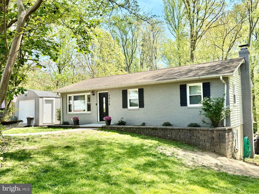 Tucked away on a quiet cul-de-sac in the desirable Calvert Beach Park community, this beautifully remodeled ranch-style home offers the perfect blend of comfort, style, and lifestyle. Backing to peaceful wooded surroundings, the setting provides both privacy and a serene natural backdrop.

Inside, rich wood flooring flows throughout the main level along with luxury vinyl, complementing the thoughtfully updated full bath and bright, inviting living spaces. The kitchen features sleek black appliances with matte stainless refrigerator and a functional layout ideal for everyday living and entertaining.

The fully finished lower level expands your living space with a cozy wood stove, perfect for relaxing evenings, and a walk-out that leads directly to the backyard—seamlessly connecting indoor and outdoor living. With a full bath and additional bedroom, office space, and laundry room, the lower level is perfect for added living space. The long driveway, detached garage, and carport gives plenty of room for vehicles, projects, woodworking, and more!

Beyond the home itself, the lifestyle here truly shines. Enjoy community beach access, nearby water amenities, and the convenience of shopping and dining just minutes away. Commuters will appreciate easy access to major routes, making travel to surrounding areas a breeze.

Whether you're seeking a peaceful retreat or an active, coastal-inspired lifestyle, this home delivers the best of both worlds.
