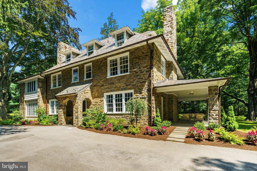 Traditional stone colonial home in Northern Bryn Mawr. A place to come home to, embracing all ages. The house has been meticulously restored by Scott Brehman who specializes in historic renovations, combining them with today’s modern living standards. The original floorplan has been retained in some areas with timeless adaptability, and other areas have been redesigned to incorporate current living needs including a third floor with a Jack ‘n Jill bath, 2 bedrooms and an open space between for a homework area/studio/playroom. There’s plenty of outdoor space with lush landscaping and a 1.3-acre lot. There’s room for a pool and/or tennis court. Enter through the stone porch into the center hall flanked by a front to back sitting room with fireplace and patio door to a covered porch. On the opposite side is the spacious family room also with a fireplace. There are hardwood floors throughout all 3 floors – some are the original random width pegged variety on the first floor. The breakfast room leads from the kitchen and has a 3rd fireplace. There’s a door out to the casual patio area off the kitchen, which  overlooks  the spectacular copper beech tree, ideal for morning coffee or pre-dinner drinks. The mudroom, at the rear of the property opens onto a level side yard, which could be a perfect location for a pool. There is an additional bonus room above the garage which has its own HVAC system, so lends itself well to a self-contained home office. The master bedroom has a huge walk-in closet and luxurious master suite with enlarged shower, double vanities, and a large soaking tub. 3 additional bedrooms on this floor share a hall bath. Own a piece of Bryn Mawr’s history, adapted to meet today’s lifestyle. Close to train (SEPTA) and Rte 76 direct into Center city Philadelphia.