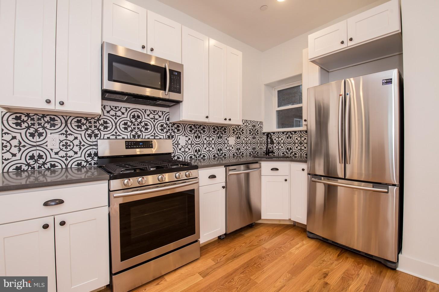 This beautiful bi-level unit is the perfect opportunity to live in this wonderfully renovated 3 bedroom, 2 bathroom space. This unit includes central air and heat, washer/dryer in unit, tons of storage and fabulous hard wood floors throughout the spacious floor plan. The posh high-end kitchen features modern white cabinetry, gray quartz counters and stainless steel appliances and Moroccan Mosaic Tile backsplash. It even has a private outdoor back-patio with plenty room for those summer BBQ s! Located around the corner from Temple University, a multitude of restaurants, sporting events and brand new parks right outside from your front door.*Sorry, no pets