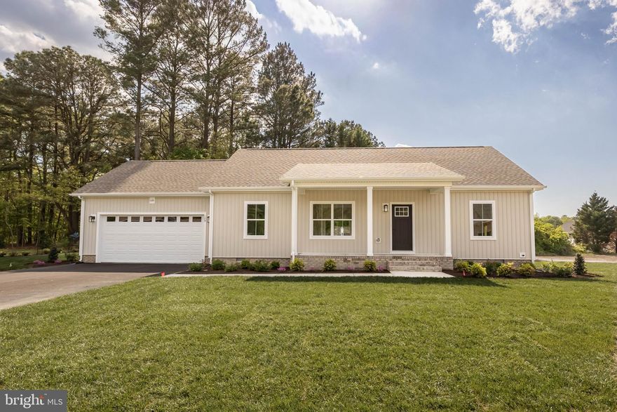 Welcome to this beautifully built 3 bedroom, 2 bathroom new construction home in Fruitland, MD, located in the Holly Hill community, offering convenient one-level living and a 2-car attached garage. As you step through the front door, you are greeted by a spacious living room that flows seamlessly into the kitchen, creating a bright and open concept layout perfect for everyday living and entertaining. The kitchen features a large island, wood cabinetry with self-closing drawers, premium quartz countertops, stainless steel appliances, and a pantry with wood shelving. A sliding glass door off the kitchen leads to the back deck, ideal for outdoor dining and relaxing. The primary suite is privately located on one side of the home and features a walk-in closet, tile shower, and en-suite bathroom. On the opposite side of the home, you’ll find two additional bedrooms that share a full bathroom with a tile shower. Interior builder upgrades include durable LVP flooring (with manufacturer lifetime warranty), wood shelving in closets, Ledo door hardware, and an upgraded Craftsman-style trim package, adding both character and quality throughout the home. Exterior upgrades include CertainTeed siding, IKO Cambridge Lifetime LTD shingles, MI V3000 Series windows (by Miter Brands), upgraded exterior lighting, and a landscape bed package, providing lasting curb appeal. This thoughtfully designed home offers modern finishes, efficient design, and quality craftsmanship—all on one level for easy living. Low HOA fee of $375 annually. Schedule your tour today! *Interior photos are not of actual home, but of similar model*