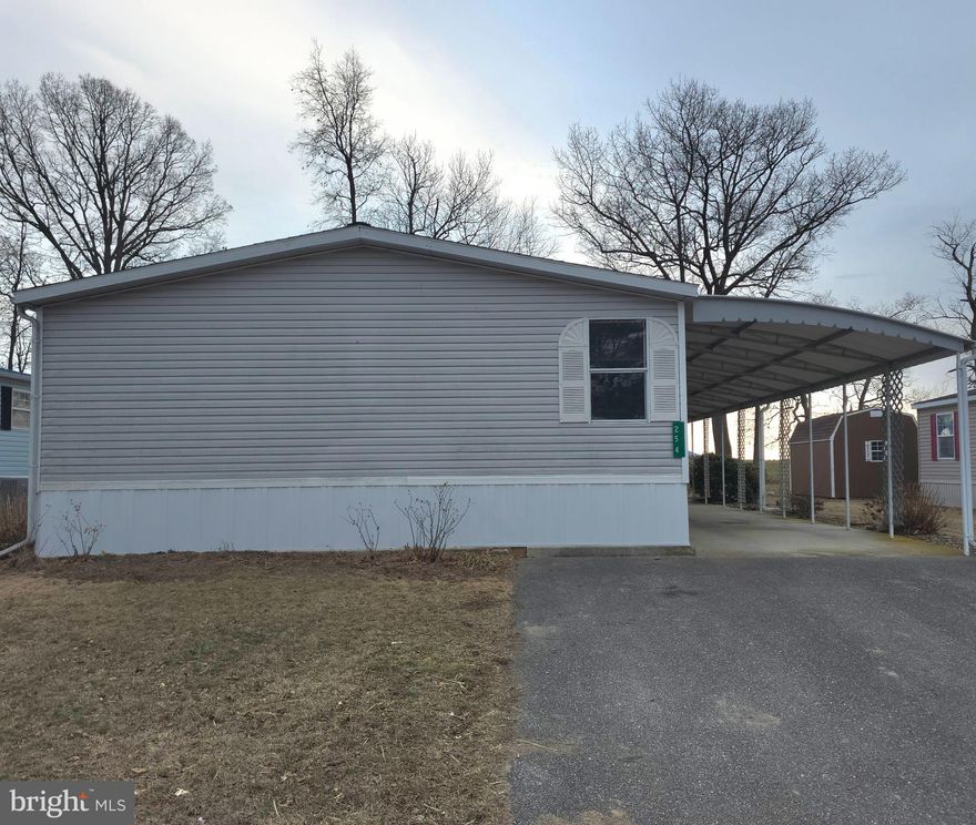 If you're looking for a nice mobile for affordable living, you found it!  This 3-bedroom 2 bath mobile has brand new carpet, new fixtures in the master, and touch ups throughout. The living and dining rooms have cathedral ceilings.  Each bedroom has a large closet or 2 of them have walk in closets.  You can eat in the dining area or eat in the kitchen and look out the windows at your deck and privacy for your back yard that backs to a farmer's field.  Buyer must be park approved.