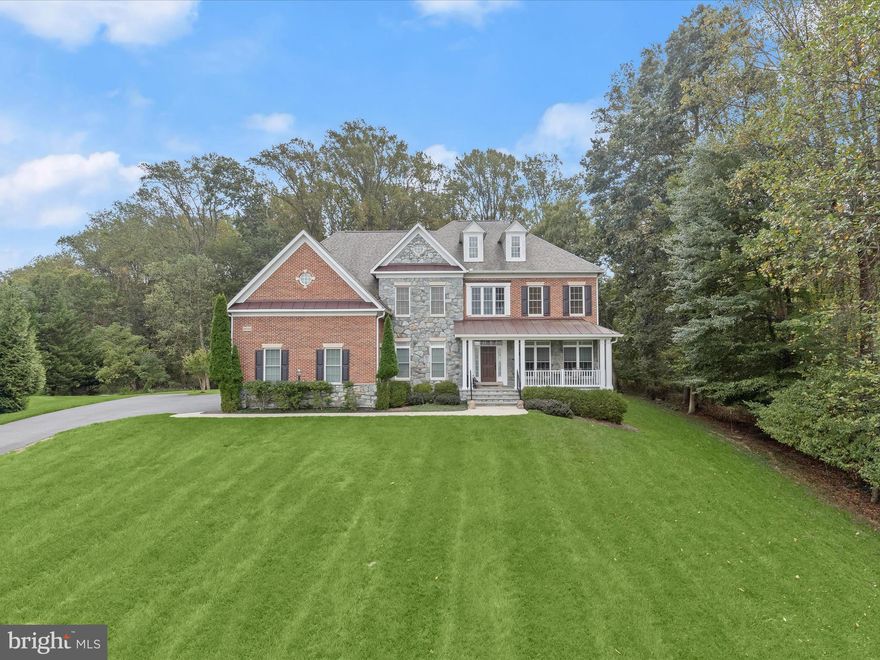 IMMACULATE!  
Welcome to this stunning, LIKE-NEW Winchester Belmont model in the sought-after Riverwood community. Built in 2011 and thoughtfully upgraded to perfection, this 5-bedroom, 4.5-bath home sits on a beautiful1.22-acre lot with Howard County preservation land on the side and rear, and common area in front, creating a very private and open feel.
Step onto an expansive front porch and enter a grand two-story foyer with a curved staircase with a plush runner, walnut floors, and rich architectural moldings. The main level boasts living and dining formals with added length for a piano, a private study, and a spacious family room with a wall of stacked windows and a gas fireplace. The gourmet kitchen wraps around a commanding center island with a breakfast bar, and is equipped with a walk-in pantry, granite surfaces, and stainless appliances. The adjacent breakfast area is sided by a planning desk and secondary back stair on one side and an atrium door on the other side that opens to the Trex deck with a plumbed gas hook-up—perfect for outdoor entertaining. Plush upgraded carpeting, and a 4’ bump-out add space, comfort and function throughout.
Upstairs, the primary suite features a generous layout with a tray ceiling and two-sided fireplace that is shared by the bedroom and sitting room.  Oversized walk-in closets flank the entrance to a dramatic spa-inspired primary bath featuring a soaking tub, two separate vanities, a walk-in shower and a generous linen closet.  Three additional ensuite bedrooms provide ample accommodations. A convenient upper-level laundry completes the floor. 
Downstairs, a fully finished lower level includes a fifth bedroom, and full bath.  Full daylight streams into the recreation room through an atrium door and double walk-up stair to the rear lawn and outdoor living. Additional rooms are finished with luxury plank floors that include an exercise room, finished storage with substantial shelving and the spacious fifth bedroom.
Exterior highlights include a slate-covered front porch, brick and stone accents, a 3-car side-loading garage prepped for generator or EV charging, and a short walk-up stair. Recent upgrades bring peace of mind: new HVAC (2025), hot water heater (2021), 20-year roof (2021), and gutter system (2021). Additional amenities include a sprinkler system, sump with backup, reverse osmosis water, and radon mitigation system.
All of this is in a prime location close to Centennial Lake, great schools, shopping, dining, and parks. This truly exceptional home has been meticulously maintained and shows like a model.  Offering a rare opportunity combining luxury, function, and location with a home in pristine condition.  This home is move in ready and simply better than new!