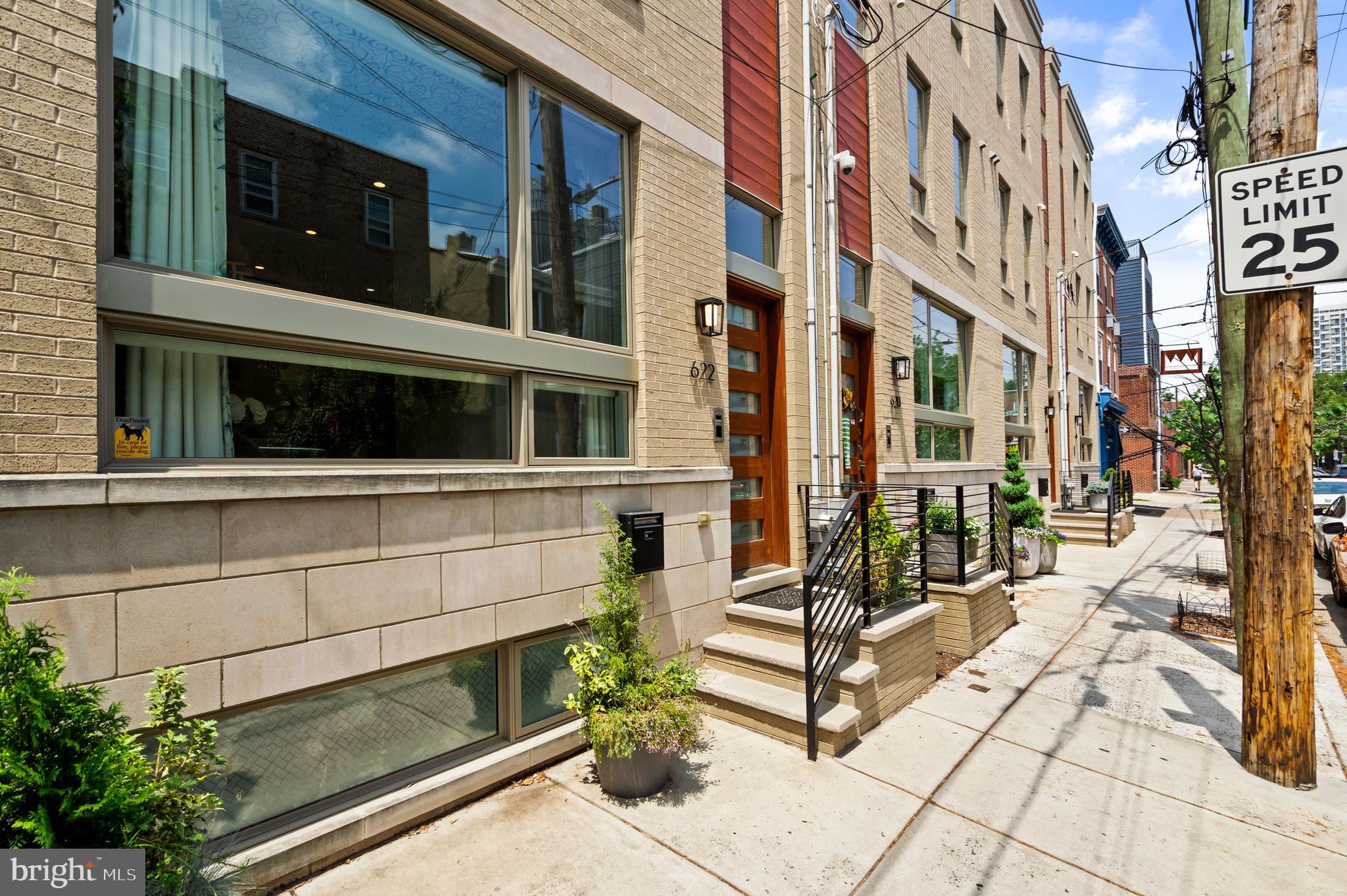 Rare and stunning home in Bella Vista with roof deck, elevator and private parking. Built in 2018 with over 4000 sq ft of living space, this home features streaking design with every upgrade and amenity imaginable.
Step into the spacious entryway, where you're greeted by a large coat closet featuring custom storage solutions. Continue up to the open dining area and gourmet kitchen. The dining room boasts elegant ceiling wallpaper, ornate light fixture, and space for a dining table that comfortably seats over 10 guests.
The chef’s kitchen is equipped with high-end appliances, including a stainless steel Wolf cooktop, double wall ovens, an oversized Sub-Zero French door refrigerator, and a beverage fridge. The expansive island and countertops are made of white marbled quartz, and the pantry and cabinets include under-cabinet lighting and custom organization systems.
The home is wired for sound with built-in speakers in the kitchen and on the roof deck. A few steps down, you'll find an elevator—servicing all levels from the basement to the rooftop—and a rear living room with 12-foot ceilings and a wall of windows that open to the private backyard and gated parking area. This space is perfect for entertaining or relaxing and includes another large walk-in storage closet and a statement light fixture.
The rear patio features built-in storage and direct access to the gated parking space, which comes with a dedicated Tesla electric car charger.
Up the floating staircase to the second floor, you’ll find a large storage closet and two generously sized bedrooms, each with en suite bathrooms and walk-in closets with custom built-ins. The rear bedroom includes a tub/shower combo, while the front bedroom offers a walk-in shower.
The third floor features a convenient powder room for guests and an impressive primary suite. This retreat includes a private home office, dual custom walk-in closets ("his" and "hers"), a separate vanity area, and a spa-like bathroom with a freestanding tub, chandelier, double vanity, and a large walk-in tiled shower with a bench.
The expansive roof deck offers breathtaking views of the city skyline and river, along with built-in lighting—ideal for entertaining.
The full, finished basement includes soaring high ceilings, abundant storage, a dedicated in-law suite or home gym, and a full bathroom.
Smart home features include WiFi-enabled Lutron lighting, a security system, Nest thermostats, a Ring doorbell, and motorized blinds. The HOA offers access to a private, gated area exclusive to residents.
Conveniently situated in sought-after Bella Vista, this home has a tax abatement available through 2028 and offers easy access to Whole Foods, shops, dining, parks, and is in the coveted Meredith School Catchment. With excellent schools and transportation nearby, it's the ideal place to call home for families and professionals alike.
