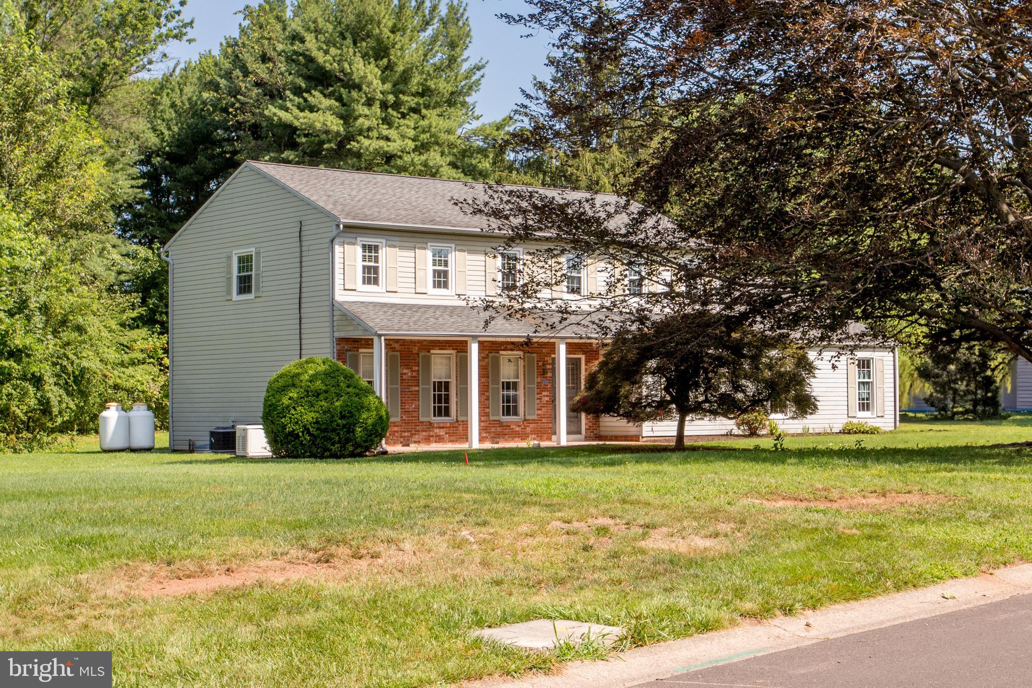 Fantastic Opportunity in Doylestown Township! Welcome to this spacious 4-bedroom, 2.5-bath Colonial situated on a beautiful 0.91-acre lot in a delightful neighborhood—just 1.4 miles from the heart of downtown Doylestown. A brick walkway leads to the inviting front porch, accented with partial brick. Inside, you'll find a foyer with hardwood flooring, a sunlit living room with hardwood floors, and a formal dining room. The eat-in kitchen opens to a large family room featuring a beamed ceiling, recessed lights and a floor-to-ceiling brick fireplace with a raised brick hearth. Sliding glass doors lead to a rear deck overlooking the expansive backyard. The main level also includes a convenient mudroom/laundry area and a versatile office just off the foyer. Upstairs, the primary suite offers a walk-in closet, a dressing area, and a private full bath. Three additional spacious bedrooms and another full bath complete the second floor. Additional features include a 2-car attached garage, central air conditioning, generator, washer, dryer, and refrigerator. Located in the desirable Central Bucks School District, with easy access to Route 202 and all the shopping, dining, and culture downtown Doylestown has to offer!