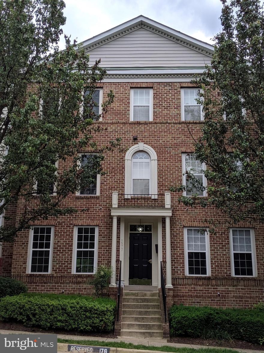 2 level luxury townhouse condo w/ many upgrades. Eat-in kitchen w/ 42" cabinets, tile floors, gas, granite counters, & under-mount sink/faucet. Kitchen opens to quiet balcony & green space. Open plan w/ high ceilings, living/dining room w/ crown molding & hardwood. Double sink MBA. Hardwood in MBR w/ crown molding & bay window. Cozy rec room. Assigned Parking. Just blocks to Silver Line Metro. Available immediately. No pets please.