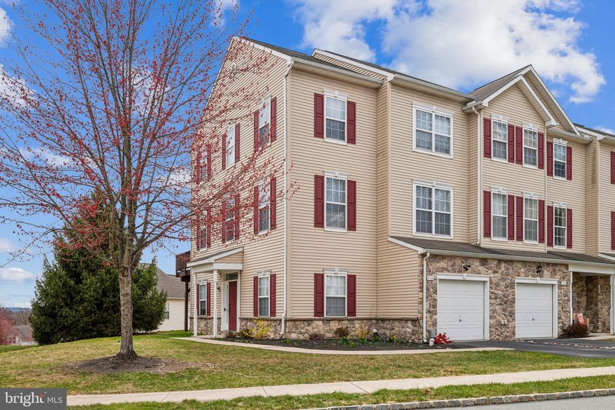 This unit cannot be rented per HOA
No FHA

Not to be missed! Move right into this amazing end unit Townhome in the Woodcrest Hills neighborhood.
Modern living at it's finest with new vinyl floors throughout the entire home that were installed in 2024. 
Enter into the Foyer and you will find a large laundry room to the right and a living space to the left which can be used as an additional bedroom, play area, office or whatever you works!
There is also an attached 1 car garage off of the first floor.  Walking up the wooden stairs to the second level which demonstrates open concept living at its finest. Here you will find the contemporary kitchen with stainless steel appliances and a half bathroom to the side, a dining area, a living room with a sliding door to a deck off of it and an electric fireplace.  This floor has a railing overlooking the foyer.
The 3 generously sized bedrooms are all on the third level with a large full bathroom in the hallway., The primary bedroom is grandiose  with vaulted ceilings, a walk-in closet, and a beautiful bathroom with a double bowl vanity and bathtub. There is tons of sunlight and closet space throughout.  Move-in ready this property will not disappoint. Schedule your showing appointment Today!