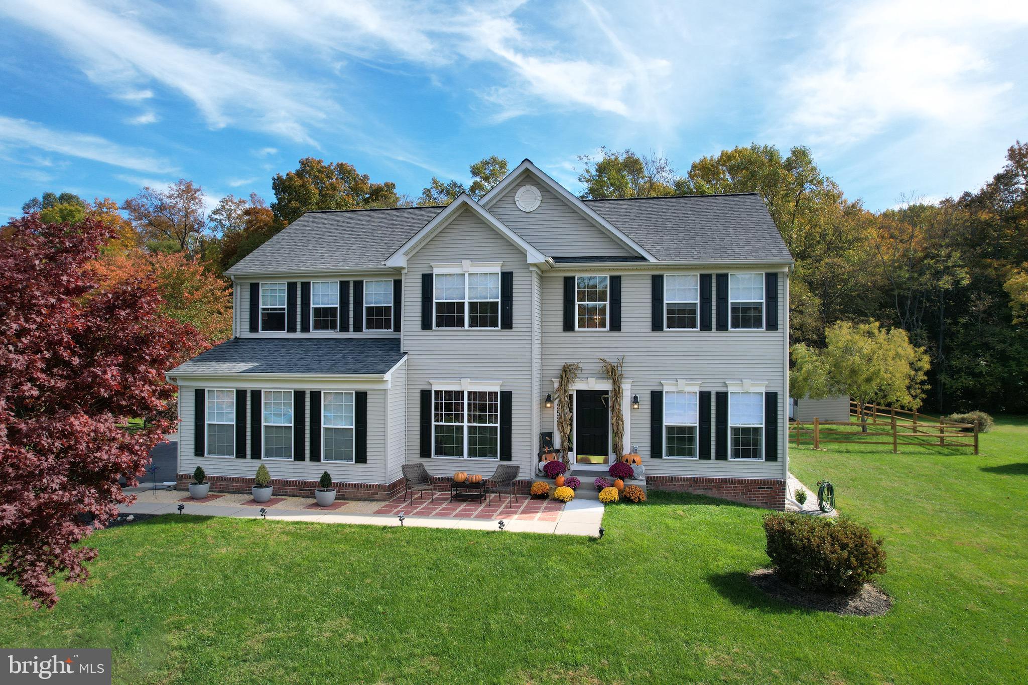 Nestled in the prestigious Rock Run Estates, this splendid 4-bedroom, 2.5-bathroom Colonial residence offers an array of desirable features and ample space. The inviting front patio sets the tone for a warm welcome. Upon entry, a grand 2-story foyer boasts hardwood floors, creating a striking first impression. French doors open into a versatile den/office, ideal for those seeking a private workspace. The main level showcases a harmonious blend of carpeted living and dining areas featuring crown molding and chair railing, adding a touch of elegance. The kitchen is a chef's dream, boasting rich cabinetry, granite countertops, stainless steel appliances, an island with a cooktop, and a pantry. Natural light floods the beautiful breakfast room, highlighting the vaulted ceiling and providing access to the outdoor patio for a seamless indoor-outdoor experience. For relaxation, the family room offers a cozy fireplace and a spacious layout, perfect for both intimate gatherings and entertaining. A convenient half bath completes this level. The upper level reveals a luxurious primary suite with an attached bath featuring a soaking tub, stall shower, double sinks, and a bonus space currently utilized as an office. The suite's coffered ceiling and double-sided fireplace exude comfort and style. Three additional bedrooms and another full bath cater to family and guests' needs, while a designated laundry area provides practicality. This property also features an unfinished basement offering endless possibilities, a fully fenced rear yard for privacy, a shed for storage, and a serene backdrop, backing to trees for a tranquil and picturesque setting. Don't miss the opportunity to make this meticulously maintained and spacious Colonial your new home.