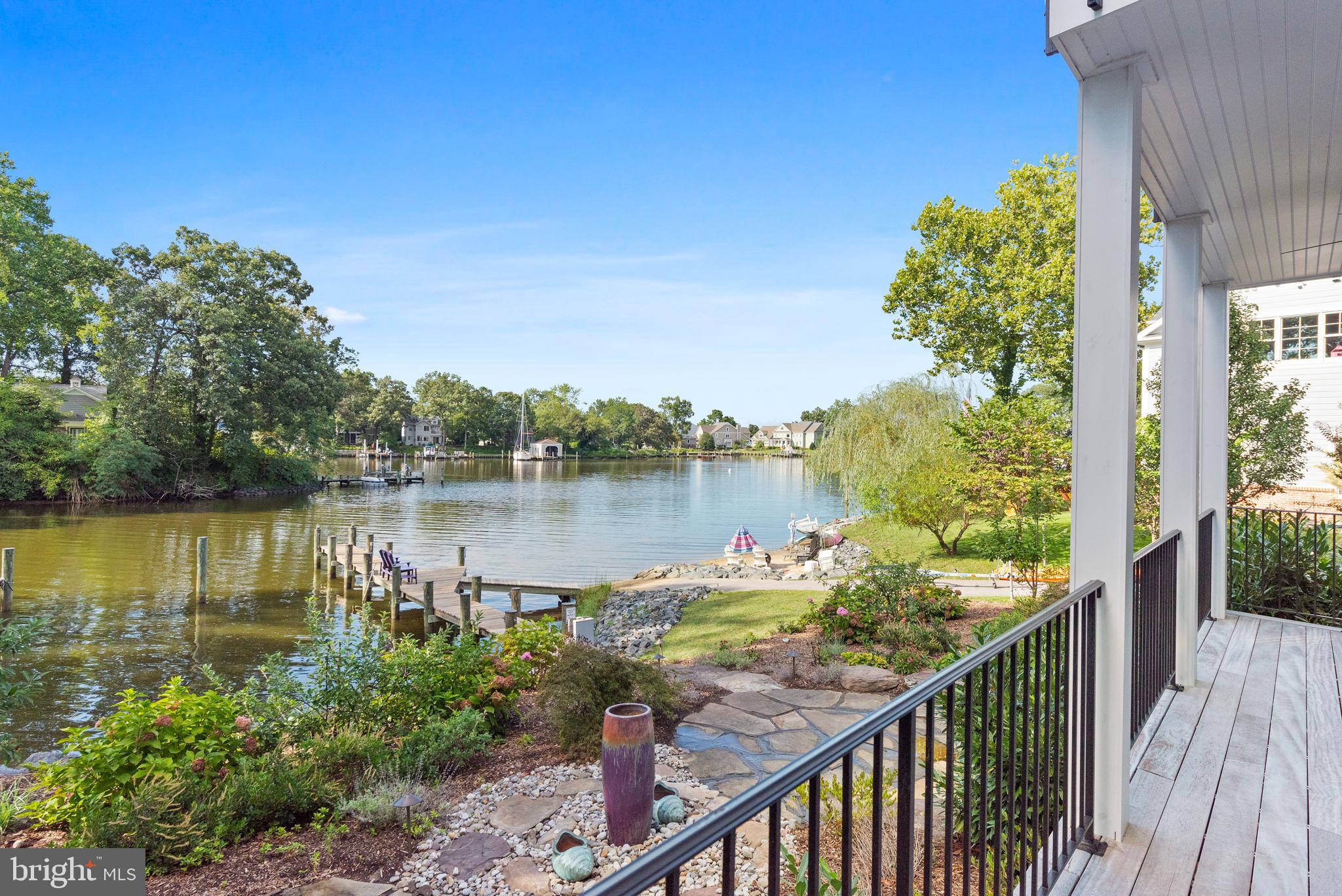 Opportunity is knocking! Live Exceptionally in this impressive waterfront estate, surrounded by 150’ of water frontage along the tranquil shores of scenic Spriggs Pond which feeds directly into the Magothy River. The 75 foot pier is private and has water and electric. MLW depth is 6 feet! Launch your craft and enjoy a day of fishing, crabbing, sightseeing, and water sports. This is a true boater's paradise! Created to enjoy sensational views and elegant interior spaces from 3 levels, this home was built to experience a true luxury lifestyle. Features and amenities include a master chef’s kitchen with top-of-the line appliances, gorgeous quartz counters, 42-inch maple cabinets, and an oversized island. Walls of soaring glass windows complement the striking views. The large, open living room with cozy fireplace will be enjoyed throughout every season. With magnificent sunset views from a private balcony, the master bedroom suite has massive walk-in closets, and it's own private laundry. Enjoy the scenery and morning coffee on multiple waterfront decking throughout the home, overlooking the gardens and waterfront. All bedrooms are expansive, each with large closets. The baths have beautiful fixtures, hand selected tiles, and sleek granite vanity tops. For added convenience the home elevator is cleverly placed, making all levels of the home easily accessible for everyone. A finished walk out basement provides a great area for movies, gaming, and entertaining. Auto enthusiasts will love the state-of-the-art garage with custom flooring and a professionally installed auto lift allowing storage for a 2nd car. The top floor is party-perfect! A full bar, entertainment kitchen, and family room brags breathtaking views! Sensational rooftop deck is the perfect spot to entertain, watch sunsets, and relax. Celebrate your Holidays and start new traditions with friends and family in this new waterfront estate. Memories are waiting.