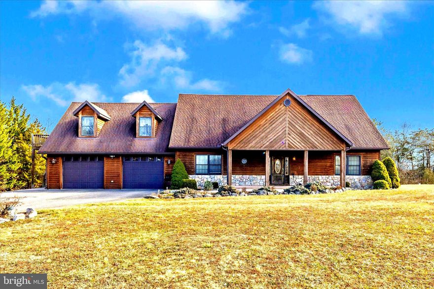 Post and beam A frame and fieldstone log cabin home in Hancock minutes from Route 70 , 68 and 65 with views that go on and on.  With floor to ceiling windows in all directions, this sundrenched home is for the nature lover and outdoorsy buyer.  On over 10 acres, with an expansive trex maintenance free deck and screened in porch, you'll watch birds, deer, turkeys and more all from the comfort of your home.  The garage houses a workshop area and an oversized 2-3 car garage with deep bays and 2 large doors.  There is an additional storage shed outside just above the start of the walking trails that saunter down through your own personal forest.  Back in the house - The bedrooms are ensuite and spaciously appointed with a walk in closet and additional storage.  The granite kitchen and island are highlighted by in cabinet lighting, natural sunlight in all directions and a lovely breakfast peninsula.  Open to the large 2 story family room and sitting area, a stunning staircase reaches additional sleeping space on the 2nd floor with a study/office/sitting nook for all of your favorite hobbies.  The laundry chute for the main house is easily accessed and laundry lands right in the lower level laundry space, steps from the kitchen island.  On the lower level, a walkout basement is featured with a propane warm stove to make for delightful ambience.  A half bath finishes off the lovely space and it's thoughtfully plumbed for a future full bath.  Beyond the finished space is a very large tool bench, shelves and storage and all of the utilities to include an electronic air cleaner and dare I say, gorgeous and organized plumbing and heating.  The apartment is accessed from the exterior steps allowing the tenant or family member to have their own access.  Warm and spacious by design, the one bedroom one bathroom apartment offers an open great room and a stackable laundry with a warm propane stove to create cozy ambience.  This area is special with close proximity to the C and O canal, the PA line, the WV line and parks galore - there is so much to do and the scenery is purely delightful!
