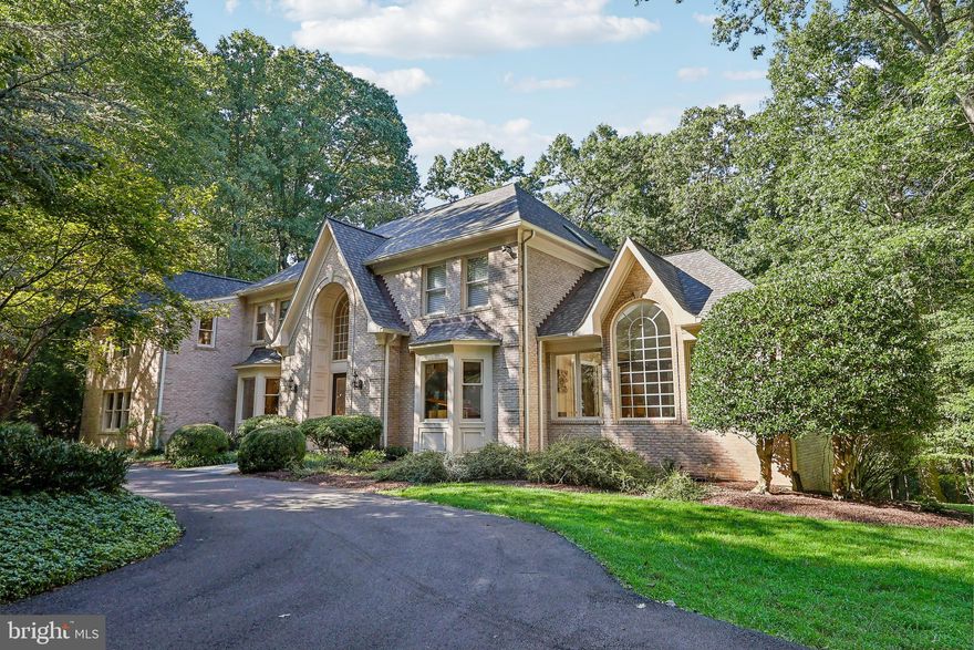 Nestled quietly at the end of a private drive, this four sided brick, Custom Colonial offers all the classic luxury you could desire.   A serene and peaceful setting with five pristine, wooded acres provides a tranquil escape from the hustle and bustle of daily life. This masterfully crafted, solidly constructed  home is filled with exceptional moldings, high ceilings and walls of windows.  Nature embraces you inside and out!  Walk through  the elegant, glass front doors and into the welcoming and dramatic Entry Foyer.   The thoughtfully designed floor plan blends the traditional with the more airy, open modern concept.  The sense of space in this house is an incredible feeling!  Do you enjoy large scale entertaining?  This home can host very large parties yet offers a warm and intimate atmosphere for more personal gatherings.  The Formal Living Room with a bay window and gorgeous custom moldings offers space for a baby grand piano.  Set quietly off the Living Room is the Conservatory with a high custom ceiling  and walls of windows providing spectacular views of the natural beauty outdoors. Also tucked away is the wood paneled Library with walls of built-ins- perfect for those working from home.  The large Formal Dining Room has a big bay window and exquisite moldings.  The piece de resistance is the stunning Two-Story Great Room/Family Room with a Persian tea rose marble and Alabaster gas fireplace, Palladian windows and exceptional moldings.   Glass doors offer access to the spacious rear deck overlooking the backyard and further back, the woodlands.  Inside, the Family Room/Great Room opens to the wonderful, updated Chef's Kitchen with a center island, six burner gas cooktop, stainless steel appliances, a wet bar and pantry.  Off the kitchen, you'll find the coveted,  practical and useful Laundry/Mud Room and a spacious Three Car Garage.  The Upper Level is comprised of four generously proportioned bedrooms and three full bathrooms.  A "bridge" connecting the bedroom spaces provides great views into the Foyer, the Great Room and outdoors.  The sumptuous Primary Suite features an expansive Bedroom with a vaulted ceiling plus a cozy and comfortable sitting room nook.  The exquisite marble primary bathroom offers double vanities, a large marble stall shower, Jacuzzi tub and separate commode room.  The Bonus Room off the Primary Suite is flexible space for a second home office, a yoga/exercise room,  a meditation sanctuary or a baby nursery.   The daylight, walk-out Lower Level is the entertainer's dream with a huge recreation room with a brick fireplace,  two  full custom built bars,  game space and a music/media room.   A walkout Au Pair/Guest Room with an en suite full bath rounds out the finished space.  The lower level provides easy access out to the level backyard with room for touch football games, kicking a soccer ball or just gazing off into the trees.  After seeing the main house, don't miss the custom built six car (tandem) garage, the ideal offering for the car enthusiast!  Along with the attached three car garage, this six car garage gives you a total of 9 secure garage parking spaces.   If cars are not your passion, use your imagination.  Would you love to have a woodworking shop, an art studio, Pilates studio--you name it.   Newer  architectural shingle roof (2021) and driveway within the last couple years.  Make your dreams come true!   This house truly leaves nothing to be desired! Ideally located in Darnestown, this home offers the best of everything - easy access to the  I-270 BioTech Corridor, Potomac Village and onwards into town.  Darnestown is loved for it's bucolic feel, community spirit, numerous parks with miles of hiking trails plus the Maryland Soccer Plex for sports activities.   It's a wonderful way of life.  Won't you make this your home today?