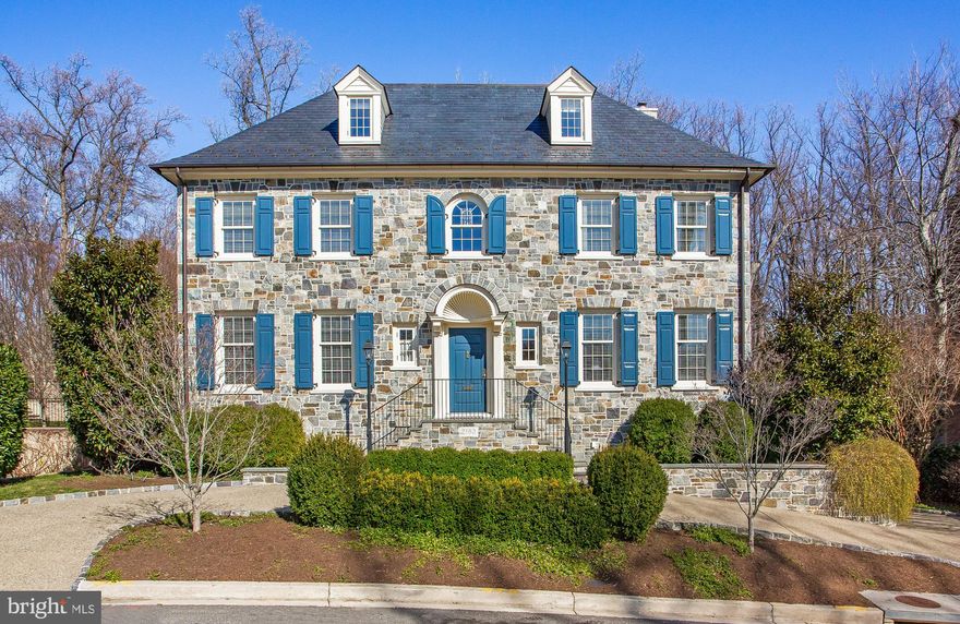 A collaboration of master builder Michael Banks and acclaimed classical architect David Jones, this elegant fieldstone residence abuts Glover Archbold Park. Soaring views of national parkland from every window on the rear of the home, and direct gate access to 183 acres of nature trails, combine sophisticated, city living with immediate access to beautiful outdoor spaces. A traditional elevation and floor plan, complemented by open kitchen/family room space, combine the best of historic quality and modern sensibilities. Architect David Jones masterfully captures light and space throughout all four finished levels.  Each room is more enchanting than the last with calming nature views and beautiful light. 10 ft. ceilings, Rift white oak floorboards, custom millwork and cabinetry, designer stones and tilework, and the finest quality brass hardware are just a few of the finish details that mark this home of timeless quality and distinction.  On the Main Level, French doors from the kitchen and family room access a stone terrace with built in grill and ample space for outdoor dining and entertaining.  Upper Levels include an oversized Master suite, office, additional laundry room and 4 secondary bedroom suites.  The walkout Lower Level accesses the two-car attached garage and includes recreation/family space, wine cellar, laundry room and additional bedroom suite.  Elevator services all four levels.  An enviable location in the Phillips Park community allows for easy access to downtown, Georgetown and area schools.
